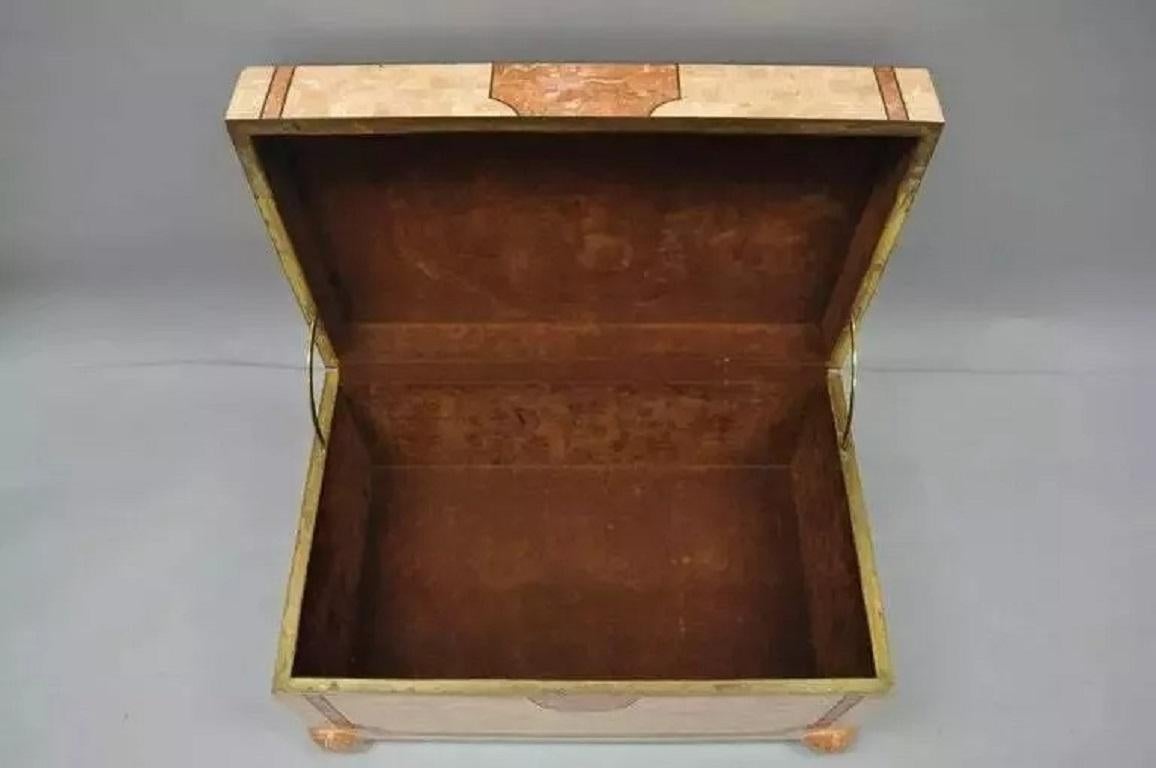 Robert Marcius Casa Bique Tessellated Stone Trunk Box Coffee Table Chest. Item features coral colored tessellated stone and brass inlays, felt lined interior, bun feet, and great quality. Casa Bique was a custom furniture maker in the 1980s that