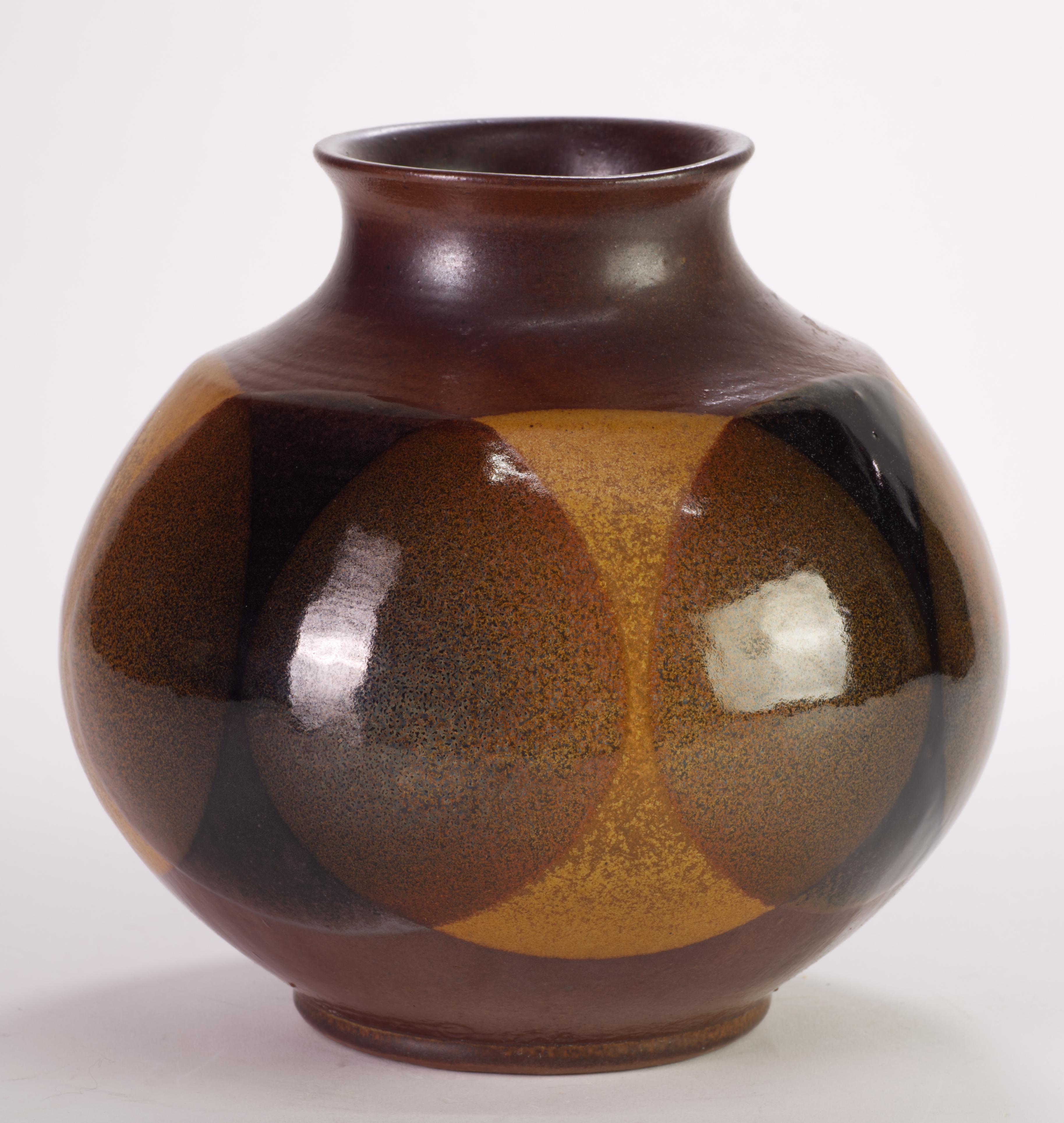  Striking modern slip-cast vase with overlapping circles motif was created by Robert Maxwell for Pottery Craft USA using his innovative glazing technique of abstract washes and layered browns and grays that became a signature look. 

Robert Maxwell
