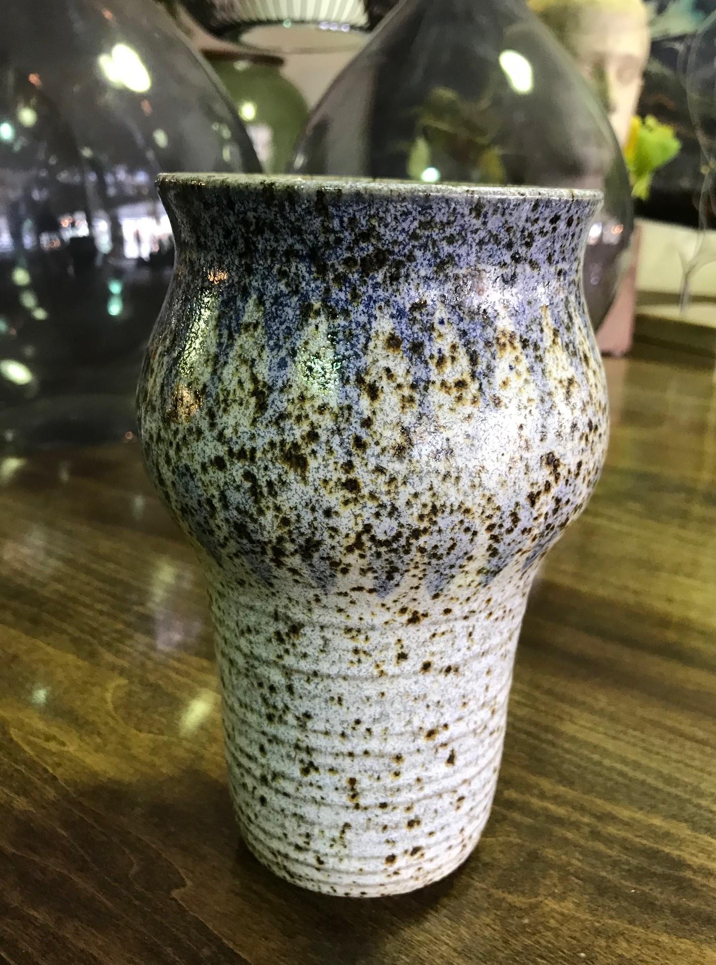 A beautifully made and wonderfully designed midcentury pottery vase by famed California ceramic artist Robert Maxwell featuring a rare blue drip glaze and deep rich colors.

Maxwell, who initially gained notoriety for his hugely popular and