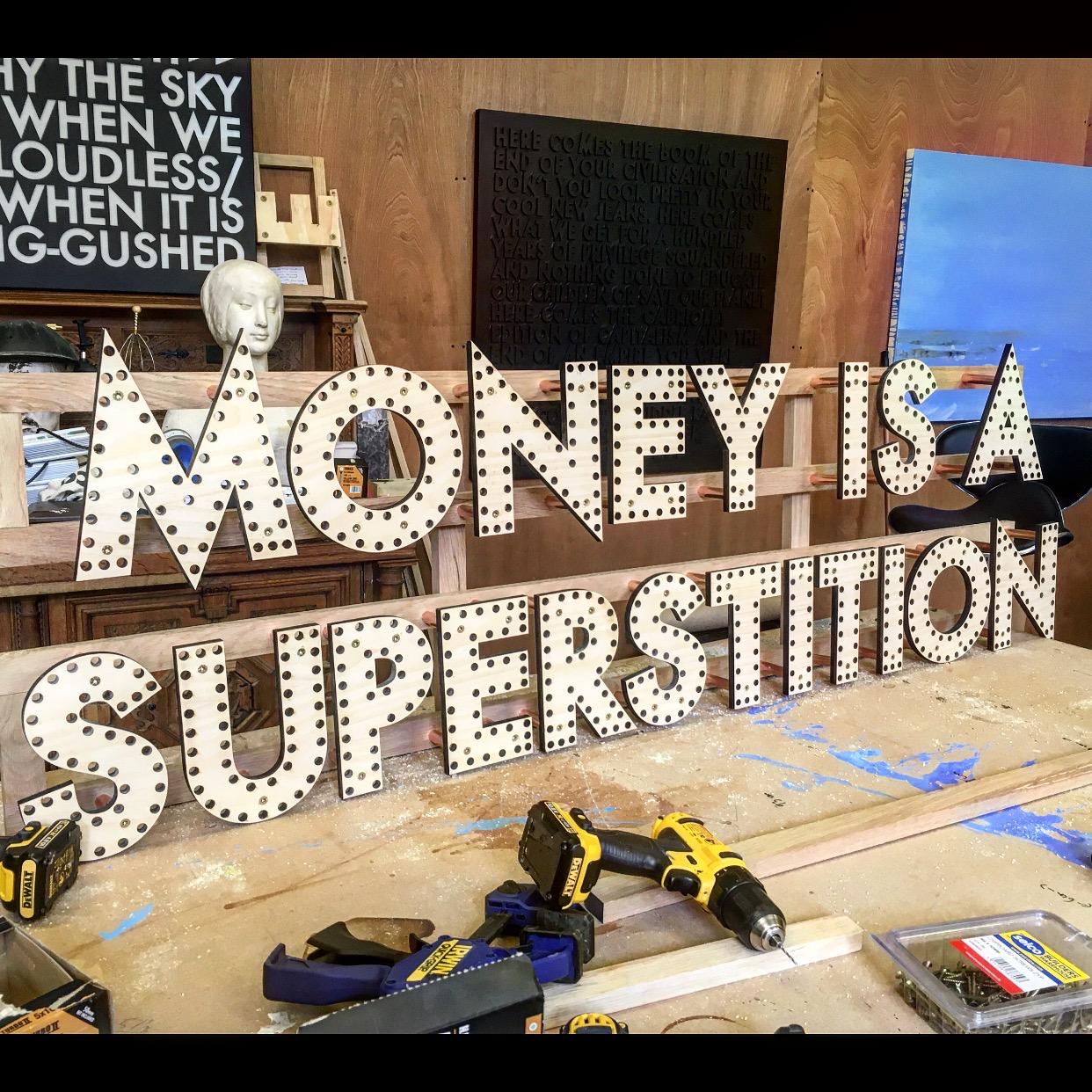 Money is a Superstition - Sculpture by Robert Montgomery