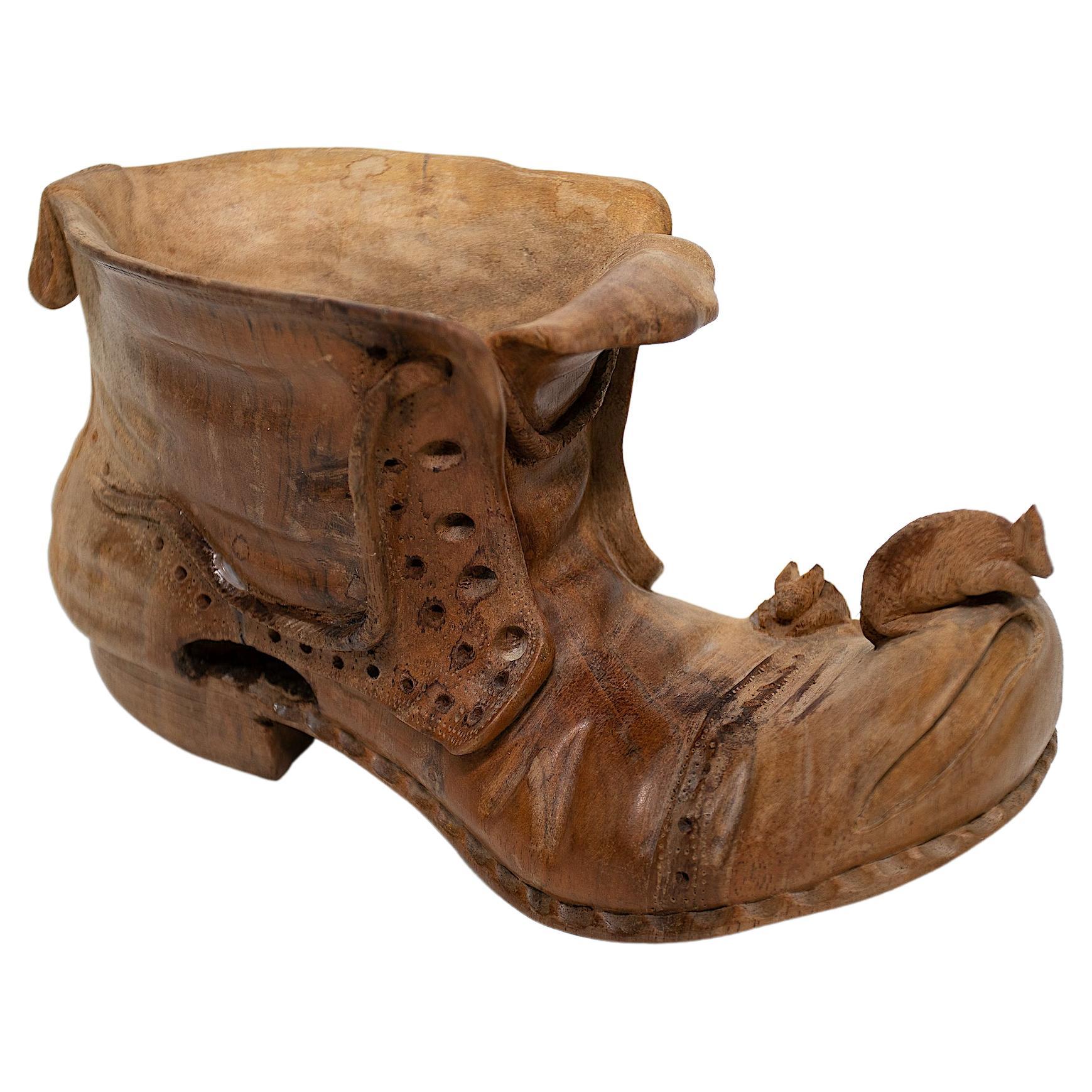 Carved wood boot with mouse