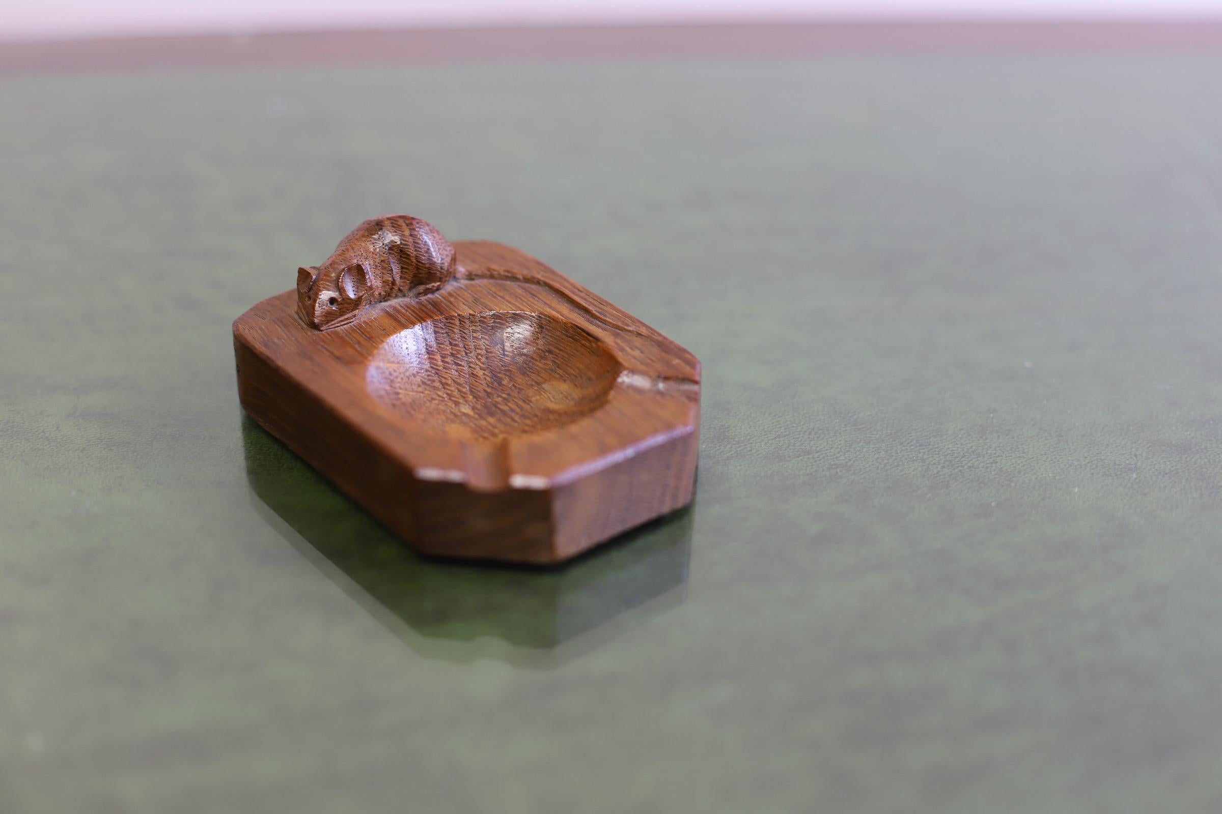 
Robert ' Mouseman ' Thompson, carved oak ashtray with mouse signature .
