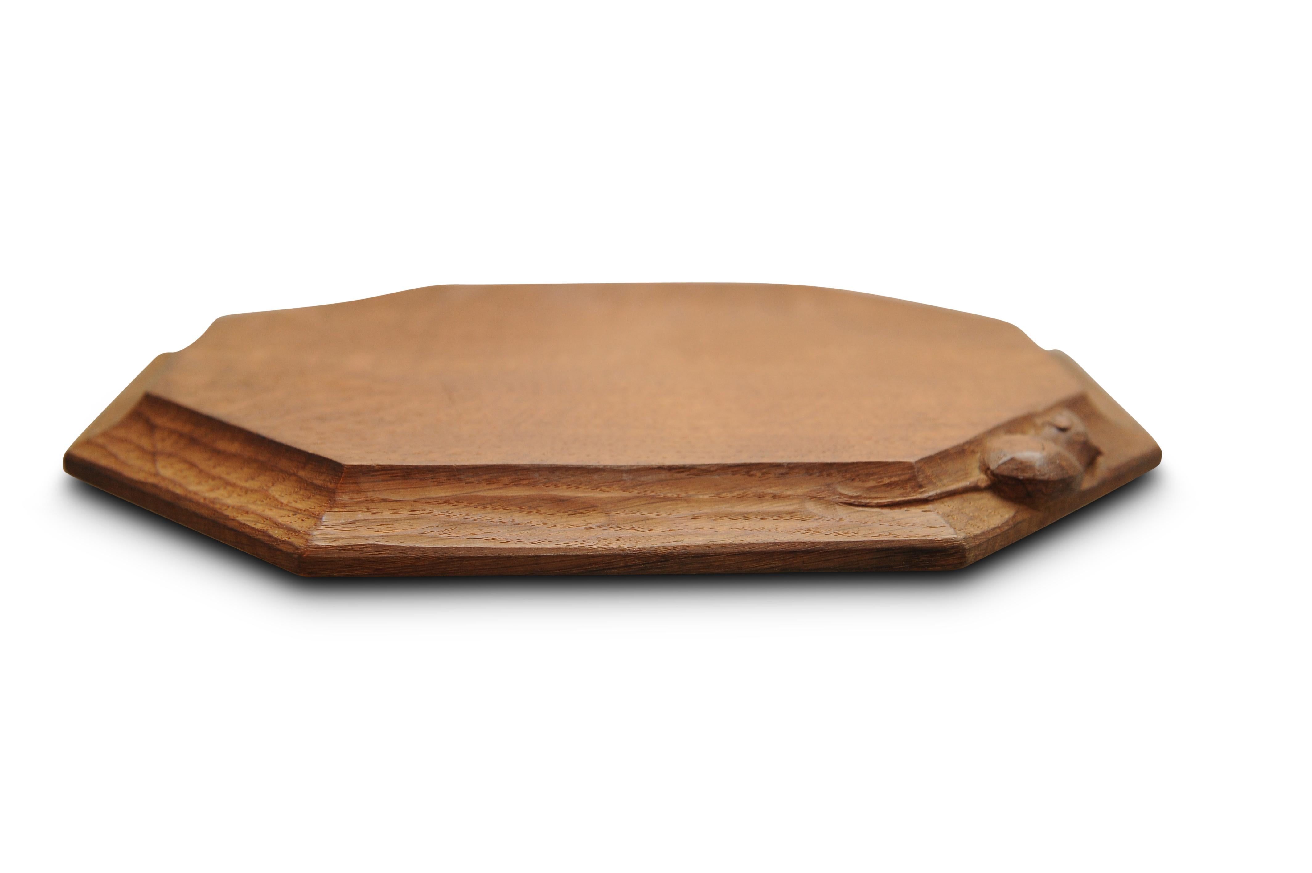 Robert (Mouseman) Thompson hand carved oak octagonal bread board with mouse motif by the English Arts & Crafts movement craftsman

Collectors item

About: Robert (Mouseman) Thompson (7 May 1876 – 8 December 1955) was a British furniture maker.