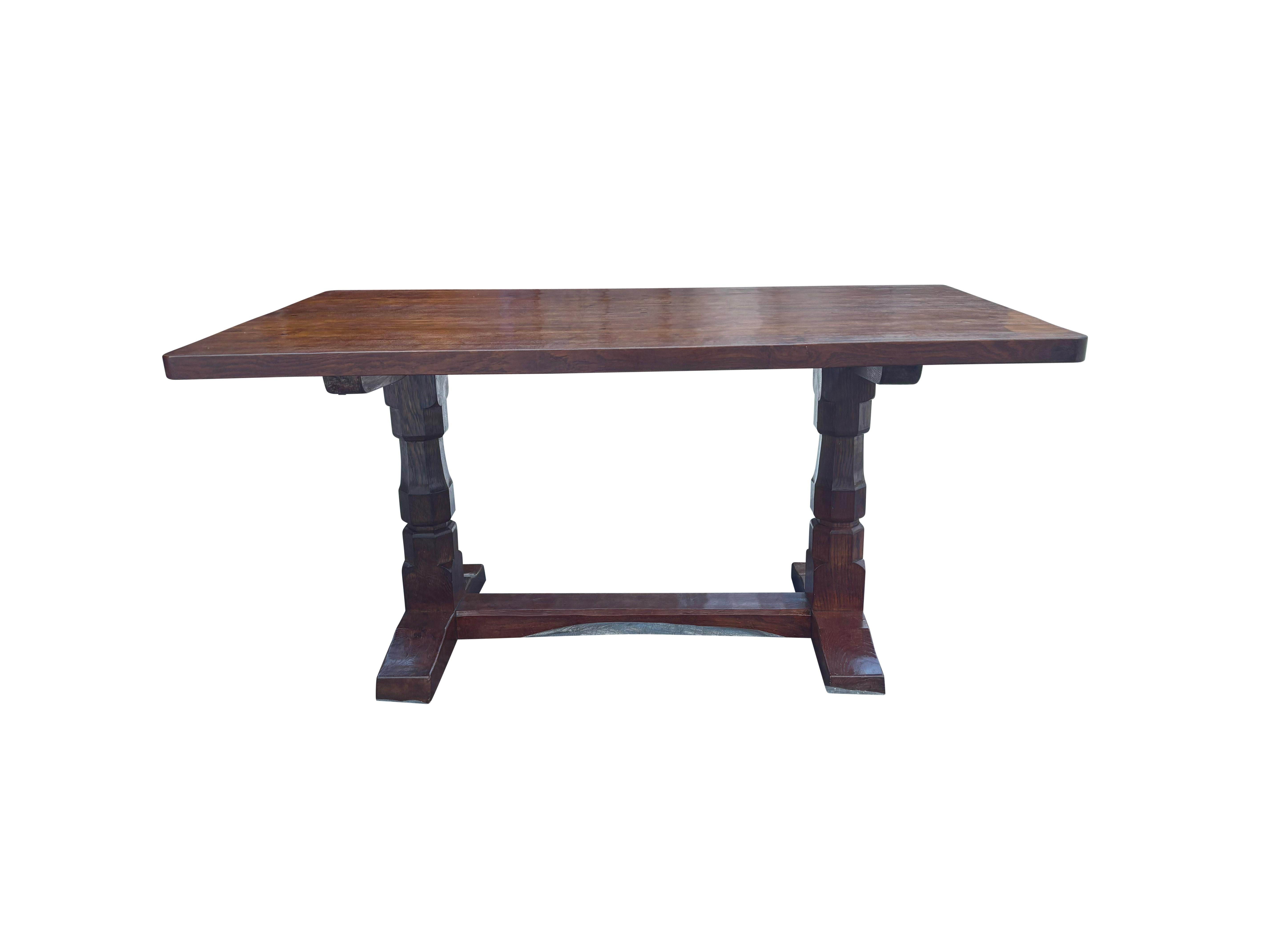 Rectangular table with trestle base With shoe feet and stretcher. Carved mouse on side of trestle. Refinished in retail ready to place in your home. Six chairs by Mouseman are available that came with the table. Given as a wedding gift to a young