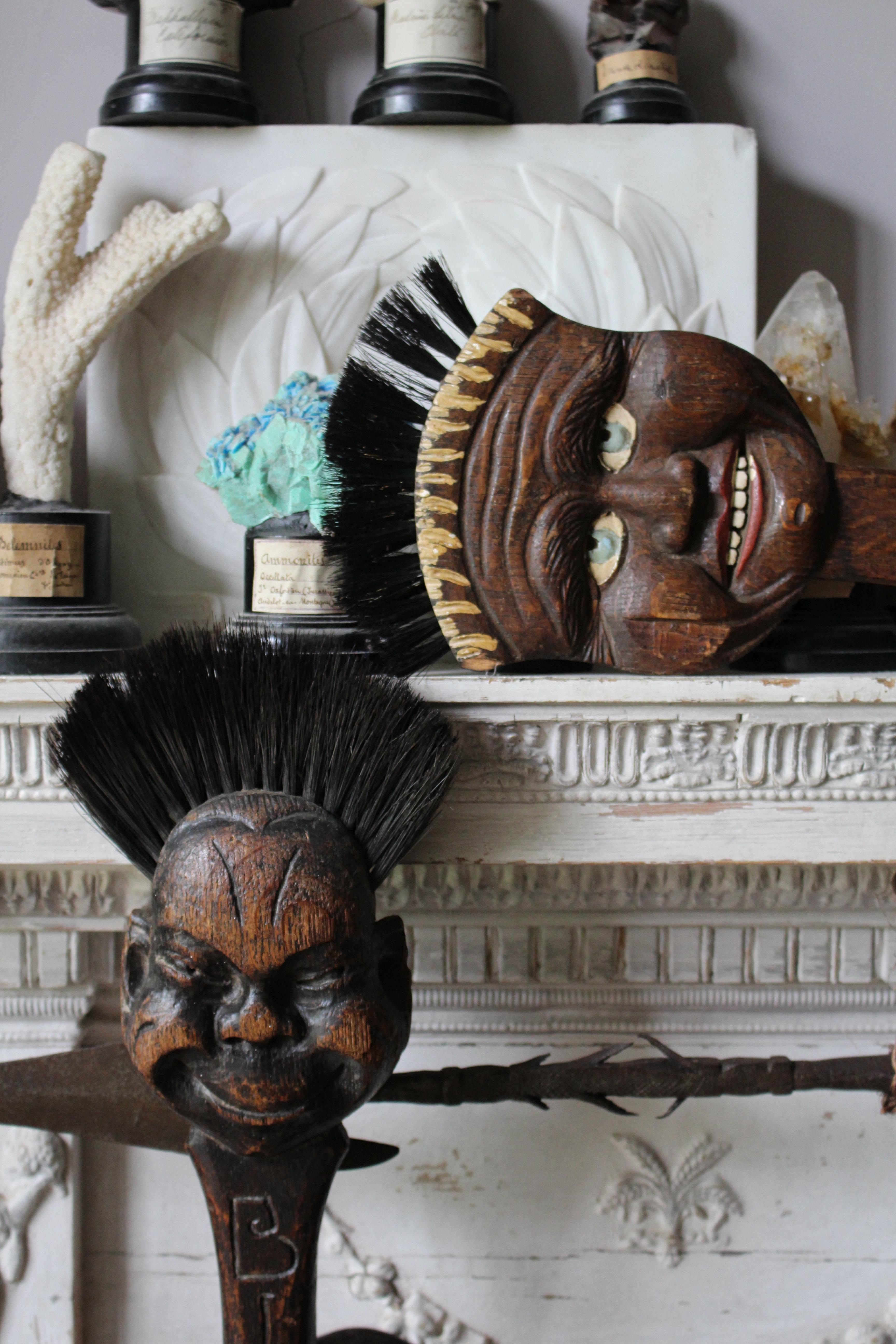 A pair of oak and horse hair fire brush's with carved grotesque masks, by the renowned furniture maker Robert 