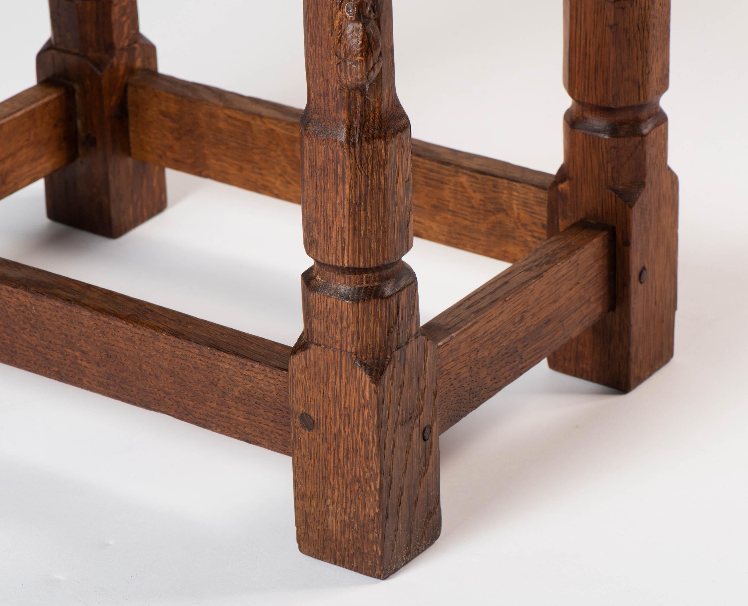 A Robert “Mouseman” Thompson rectangular stool.
English oak
Dished top on 4 octagonal legs with stretchers.
Carved mouse
English, circa 1940
Measures: 40 cm wide x 28 cm deep x 37 cm high.
 