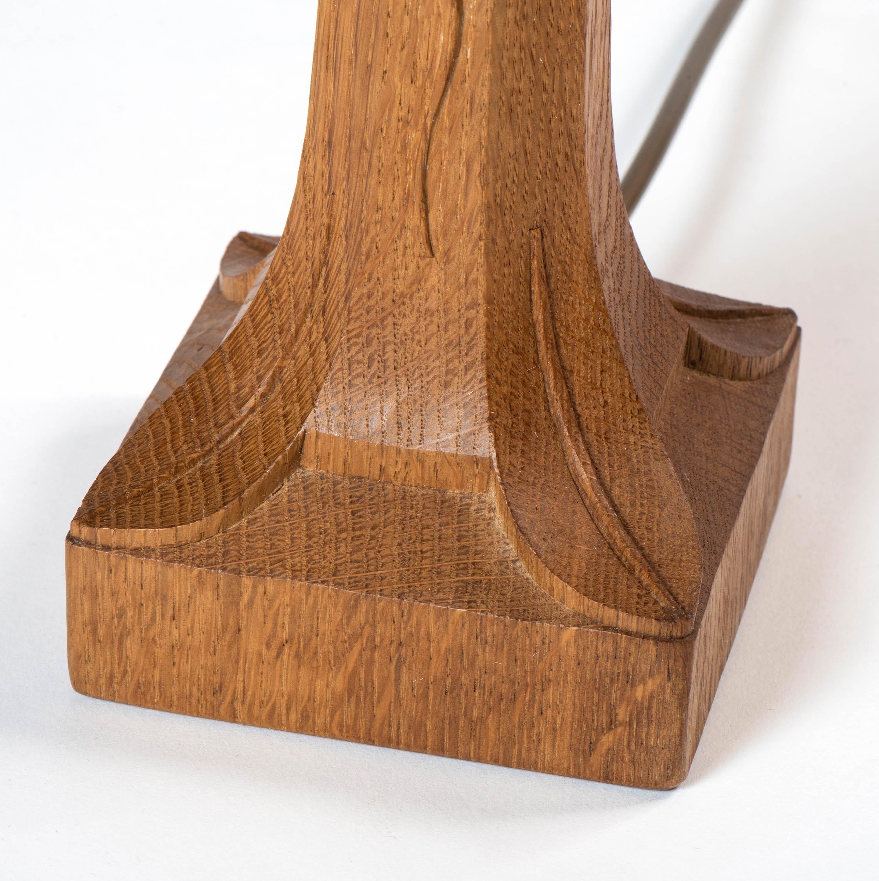 A Robert “Mouseman” Thompson table lamp.
Oak
Octagonal column on square base,
Carved mouse.
English, circa 1970
Parchment shade.
Measures: 26.5 cm high x 23 cm wide x 23 cm deep.