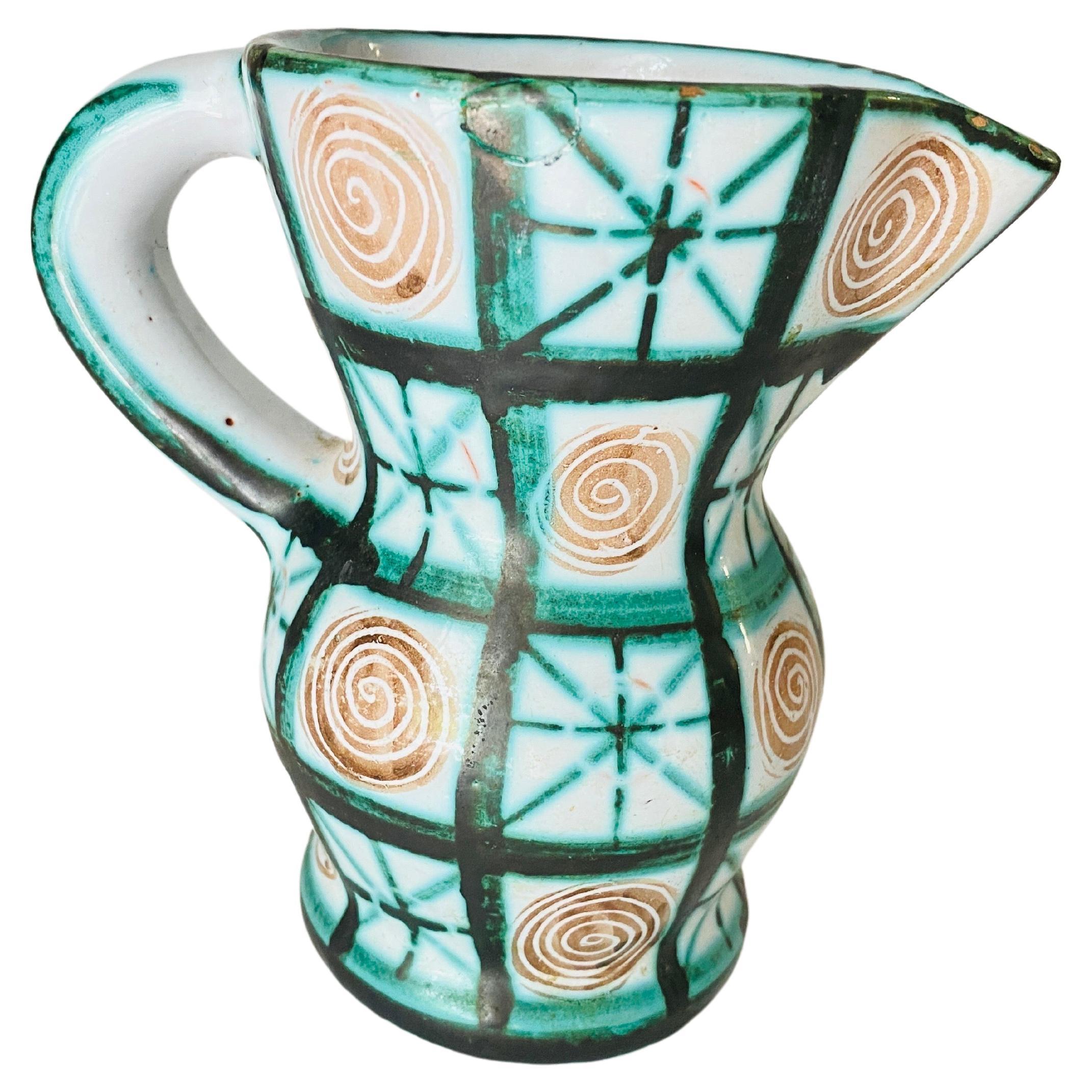 Beautiful hand painted Pitcher by Robert Picault from France, 1960's. White glaze with green and brown painted zig-zag motif. With handle. Beautiful shelf accessory. Signed.