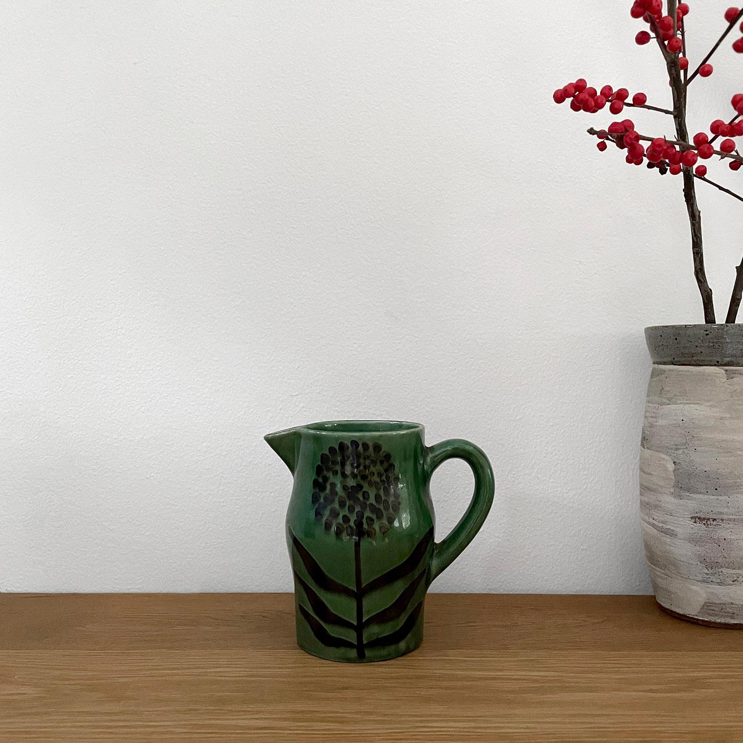 Robert Picault French ceramic pitcher vase 
France, circa 1950s 
Rich emerald green ceramic is accented with an organic floral motif
This charming piece is certain to brighten up any counter space 
Vessel has not been tested to hold water  
Patina