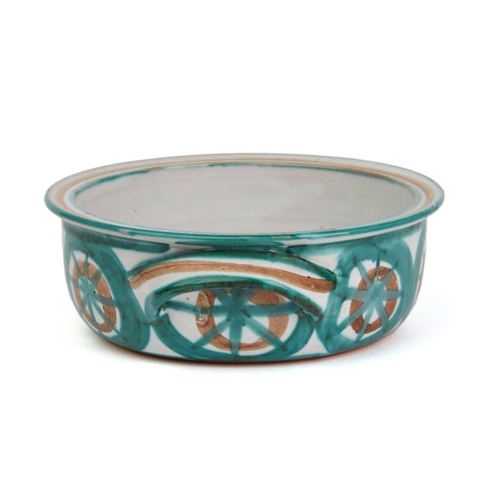 A rare and important stunning French art pottery handled serving bowl by Robert Picault and made in Vallauris in the South of France. Working closely to Picasso each piece is hand decorated with green, brown and incised patterned designs along with