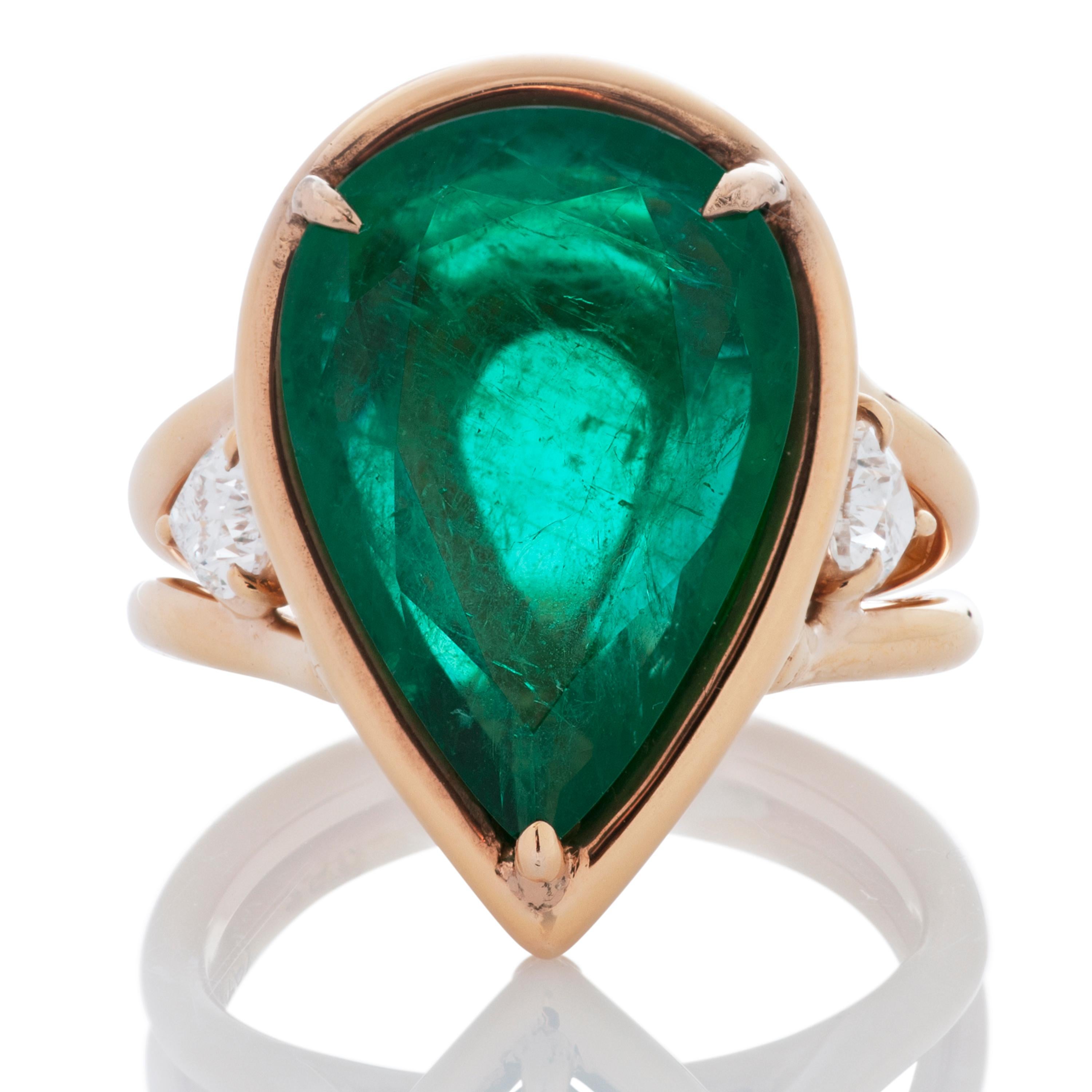 Robert Procop emerald and diamond ring in 18k rose gold.  The center stone is a 6.59 carat pear shaped Zambian emerald accompanied by a C. Dunaigre report.  The emerald is accented by 2 pear shaped diamonds totaling 0.56 carat with estimated H-I