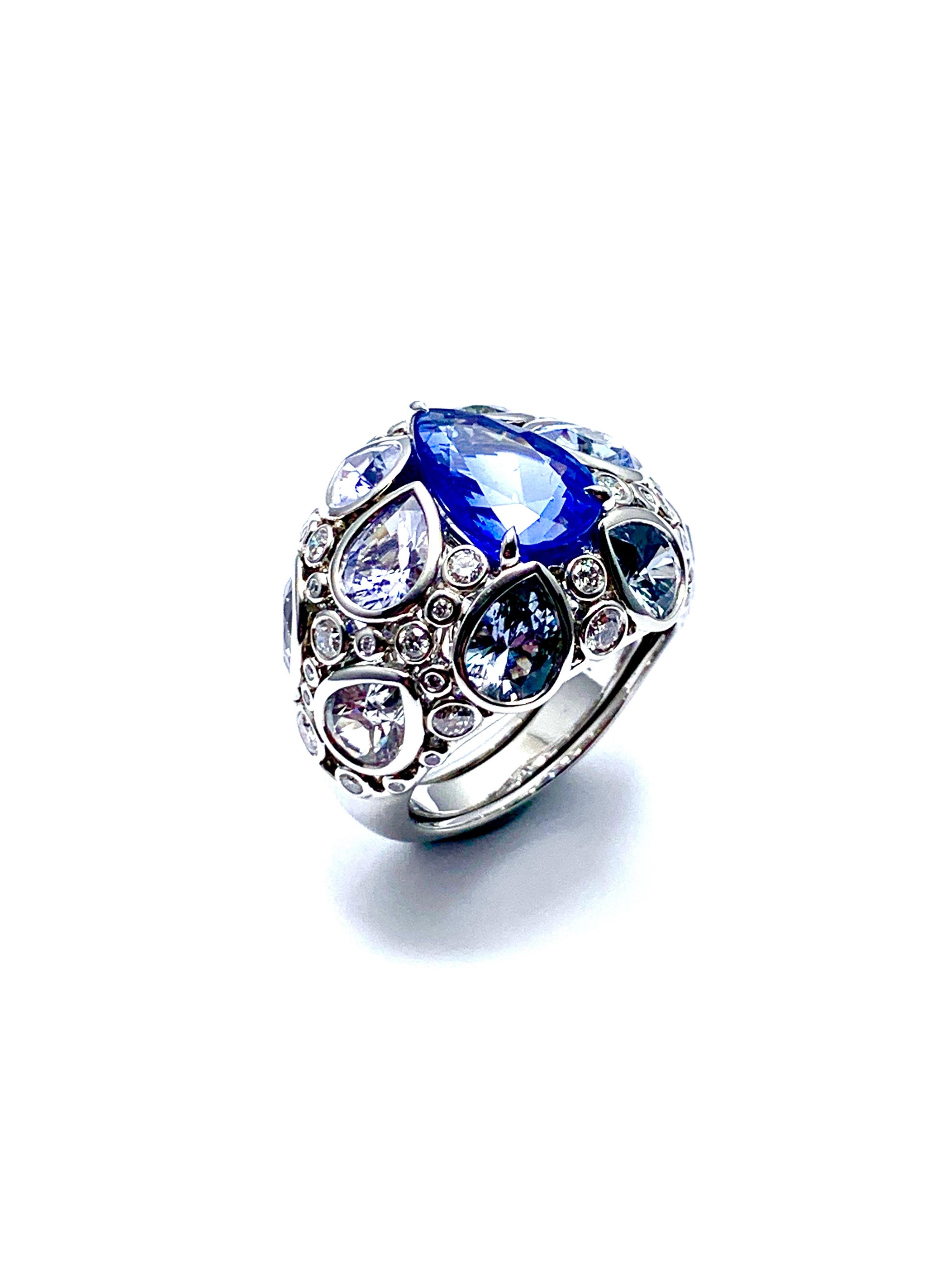 An absolutely gorgeous Robert Procop De La Vie Collection cocktail ring! The ring is handcrafted in platinum with a stunning 4.58 carat pear shape sapphire set with light blue pear shape sapphires, and round brilliant diamonds. There are 10  light