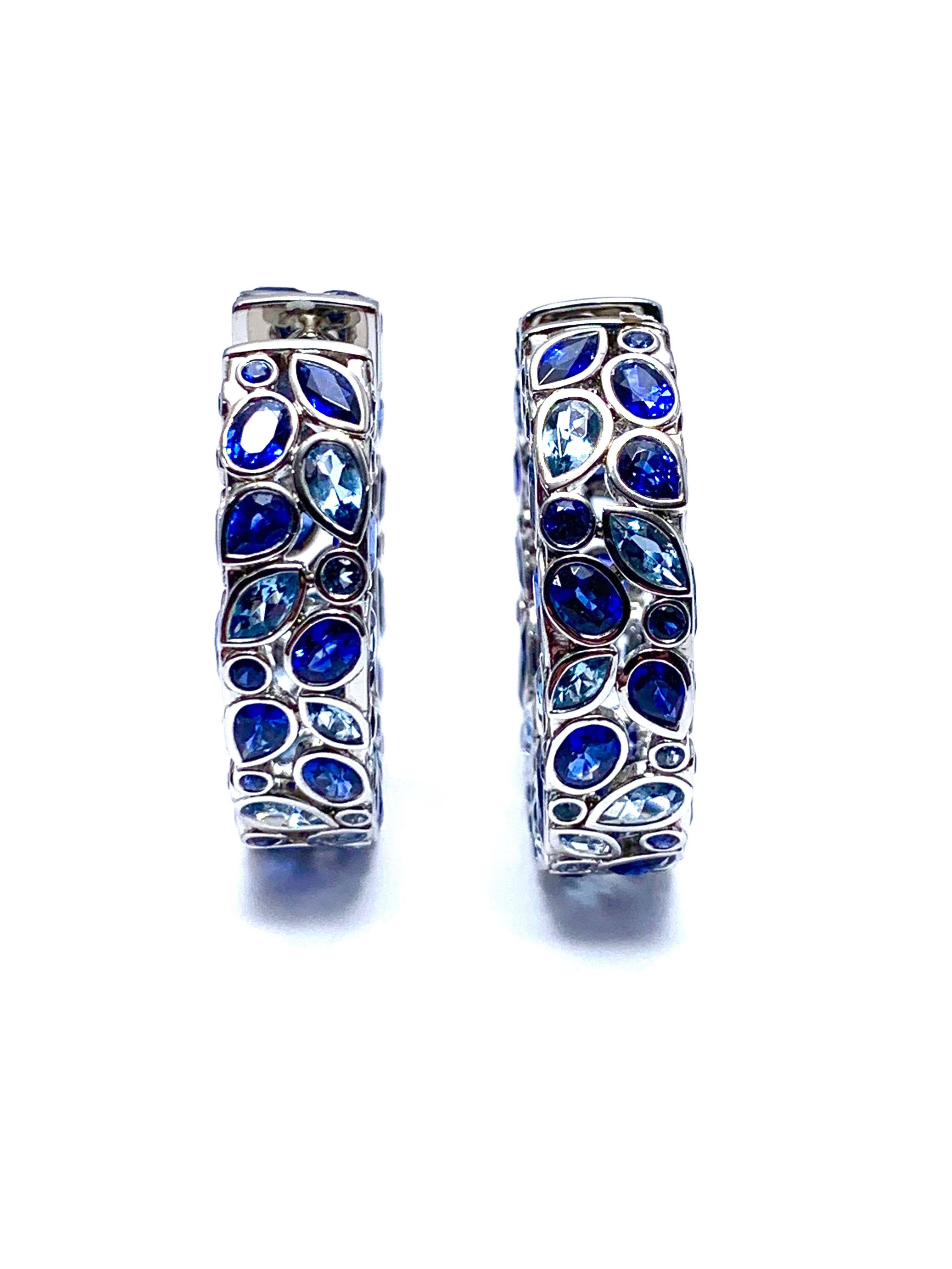 An absolutely stunning Robert Procop De La Vie Collection pair of earrings! The earrings are handcrafted in platinum with bright blue Sapphires and scintillating Aquamarines. There are 94 various shaped blue Sapphires totaling 10.26 carats, and 88