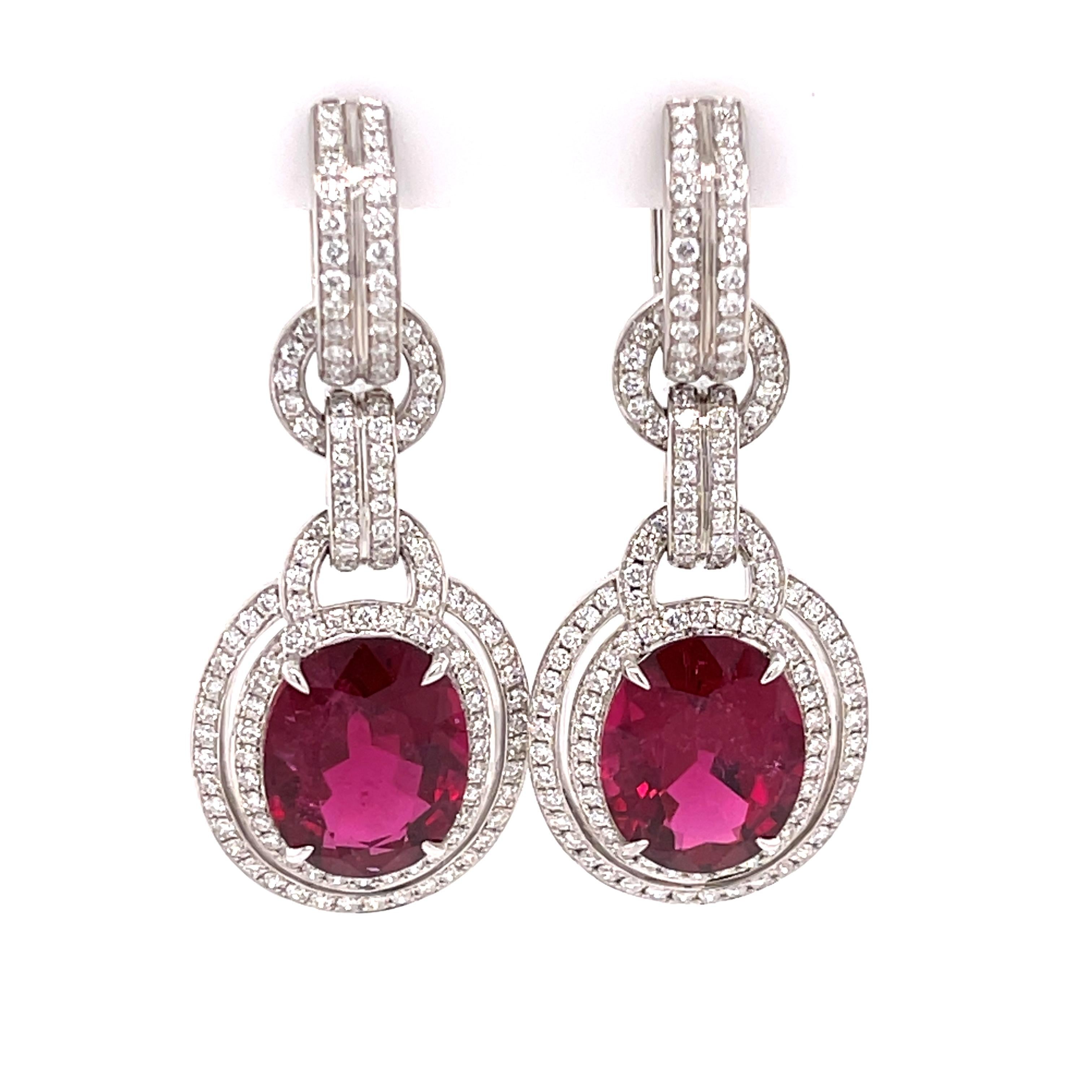 Robert Procop rubellite and diamond dangles in 18K white gold. The earrings feature two oval cut rubellites with 12.95ctw and 2.10ctw of diamonds. Stamped RP 4550 750.