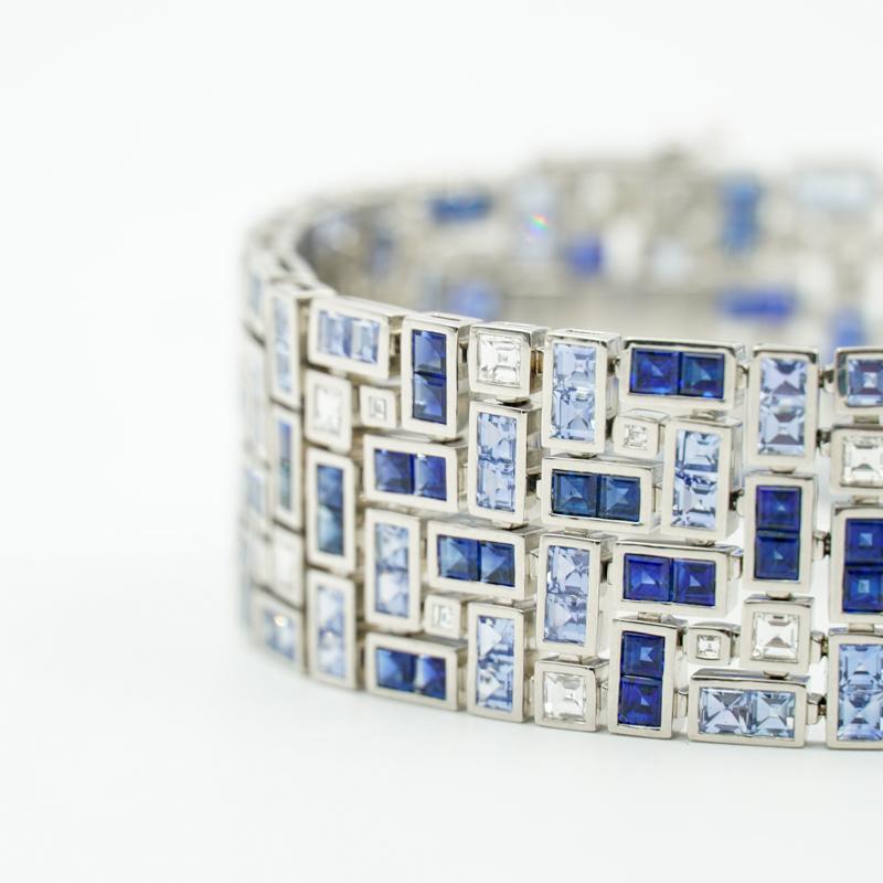 Instantly recognizable as a Robert Procop piece, this platinum bracelet has been set with square cut Sapphires (23.97 Total Weight) and Diamonds (2.69 Total Weight). 
