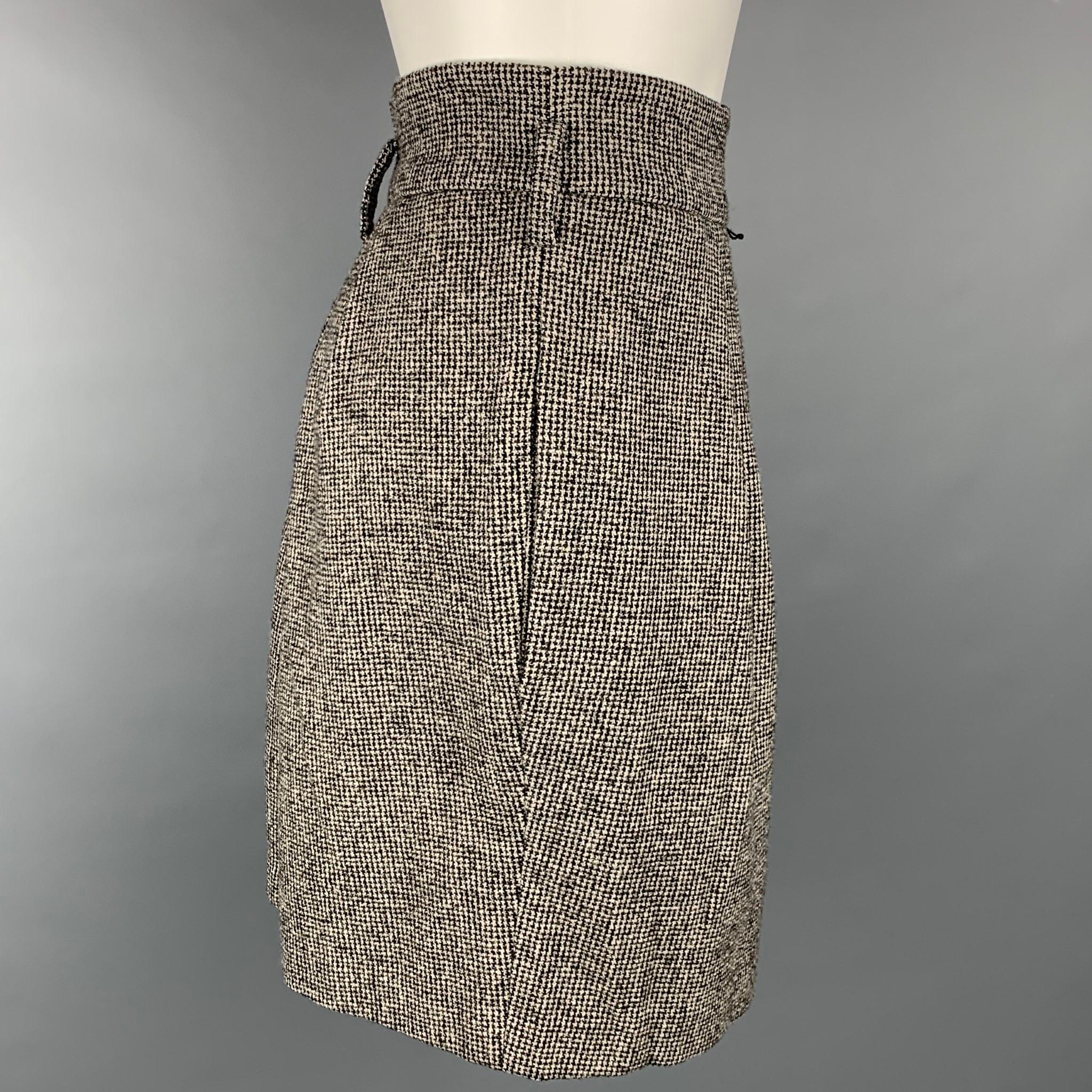 ROBERT RODRIGUEZ skirt comes in a black & cream houndstooth wool / polyester with a slip liner featuring a pleated style, wide waistband, belt loops, slit pockets, and a back zipper closure.

Very Good Pre-Owned Condition.
Marked: