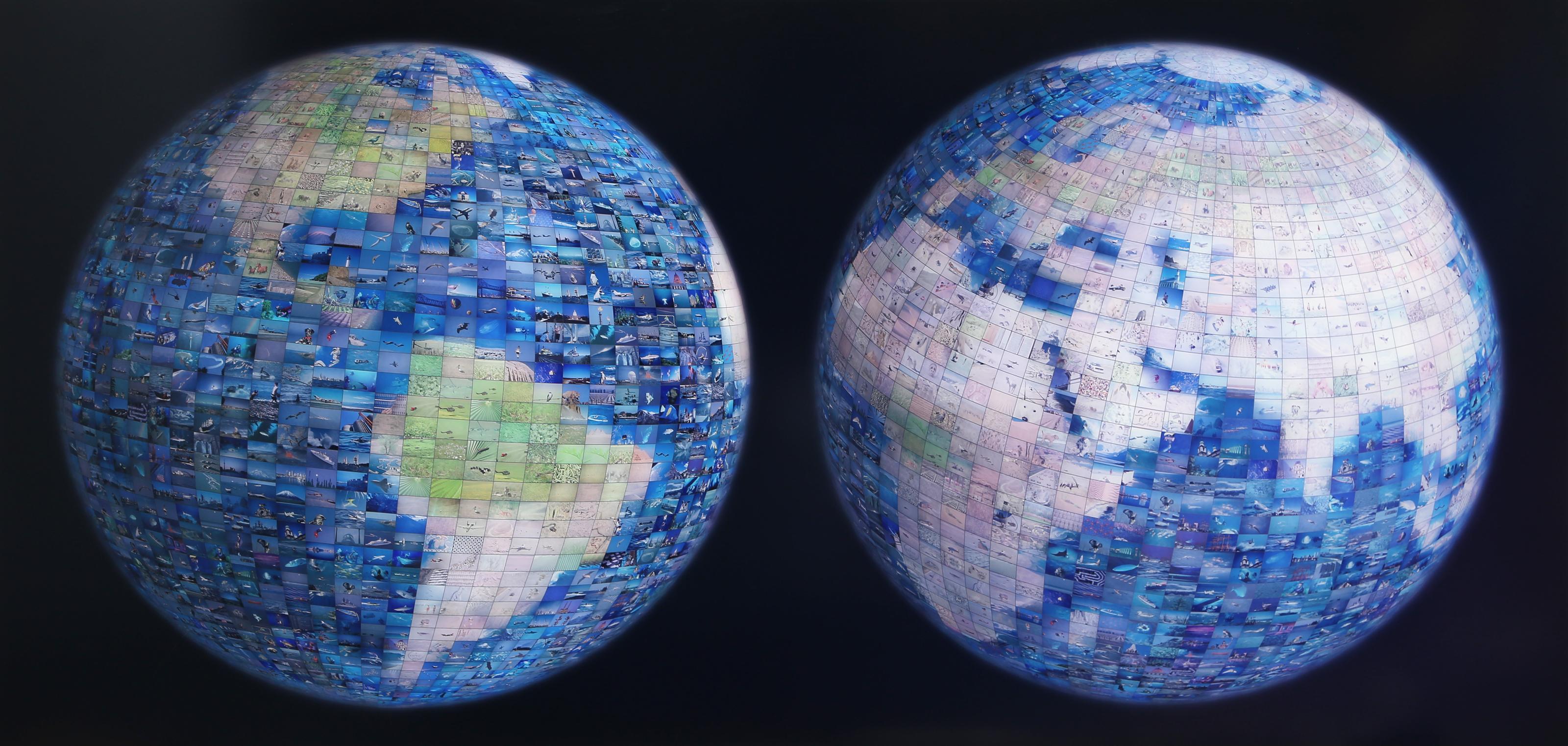“World” is a photomosaic mounted on aluminum by American artist Robert Silvers (b.

1968), dated 2001. The work depicts two spherical globe forms, each composed of hundreds of small photographs arranged to form the continents and oceans of the Earth