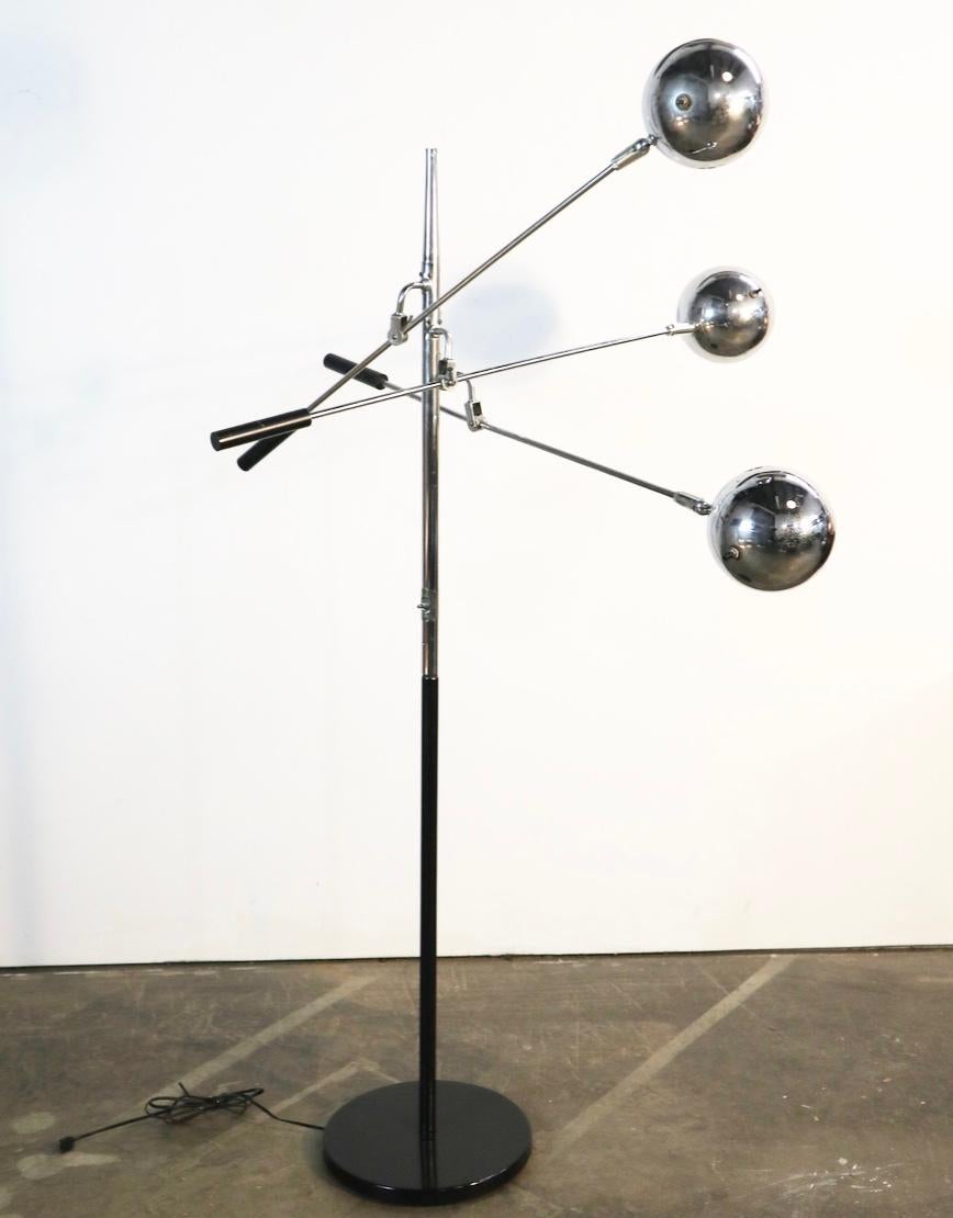 Amazing floor lamp designed by Robert Sonneman. Three adjustable arms with pivoting sockets allot for myriad configurations of form and function. All sockets function well. Chrome is good condition for age. Black disc base repainted.