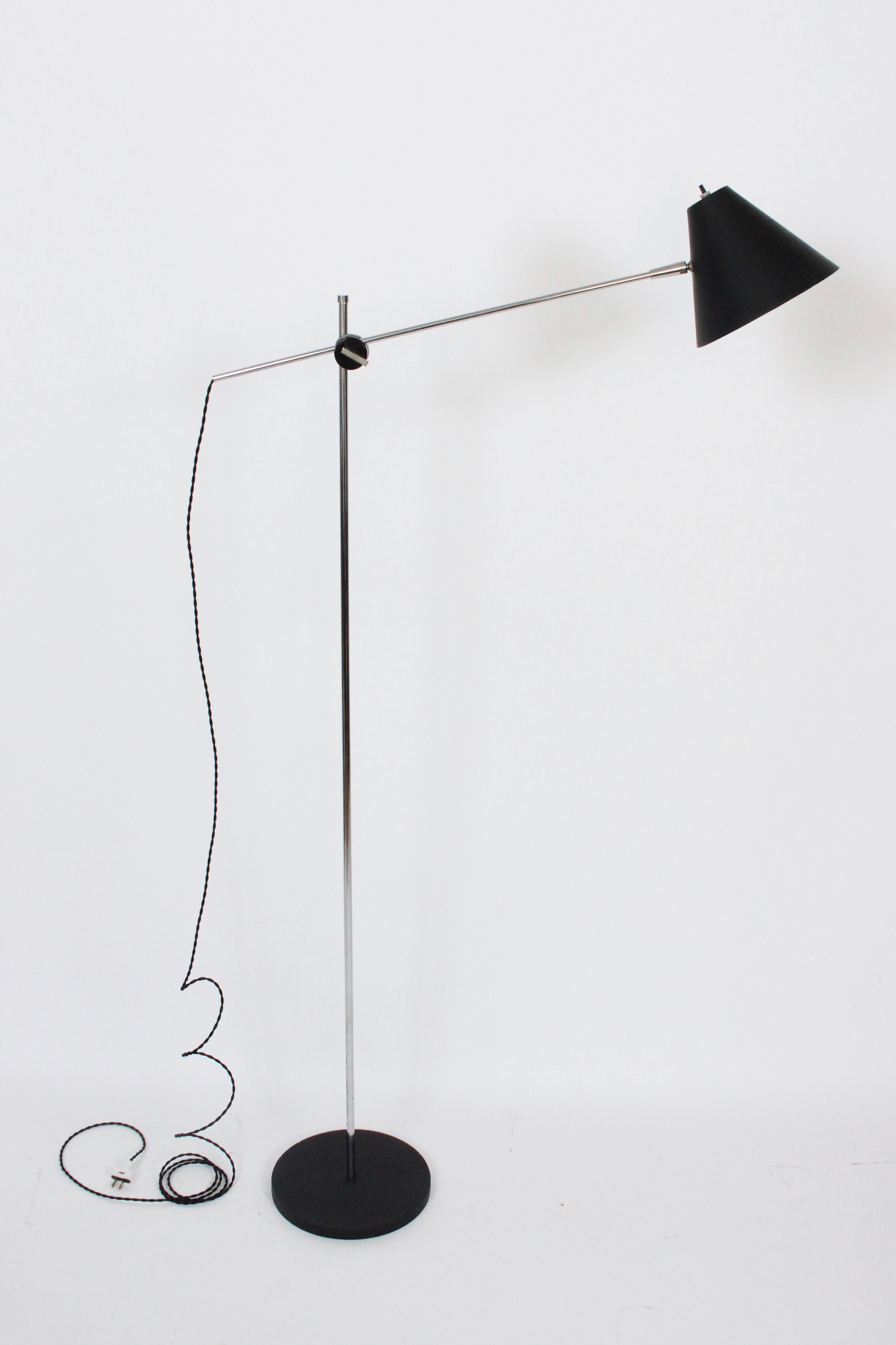 Modern Robert Sonneman for George Kovacs adjustable reading floor lamp. Featuring a tubular chromed steel stem, arm, knob, and ball socket, adjustable black enameled aluminum with white interior 8D shade within a heavy, sturdy and balanced round