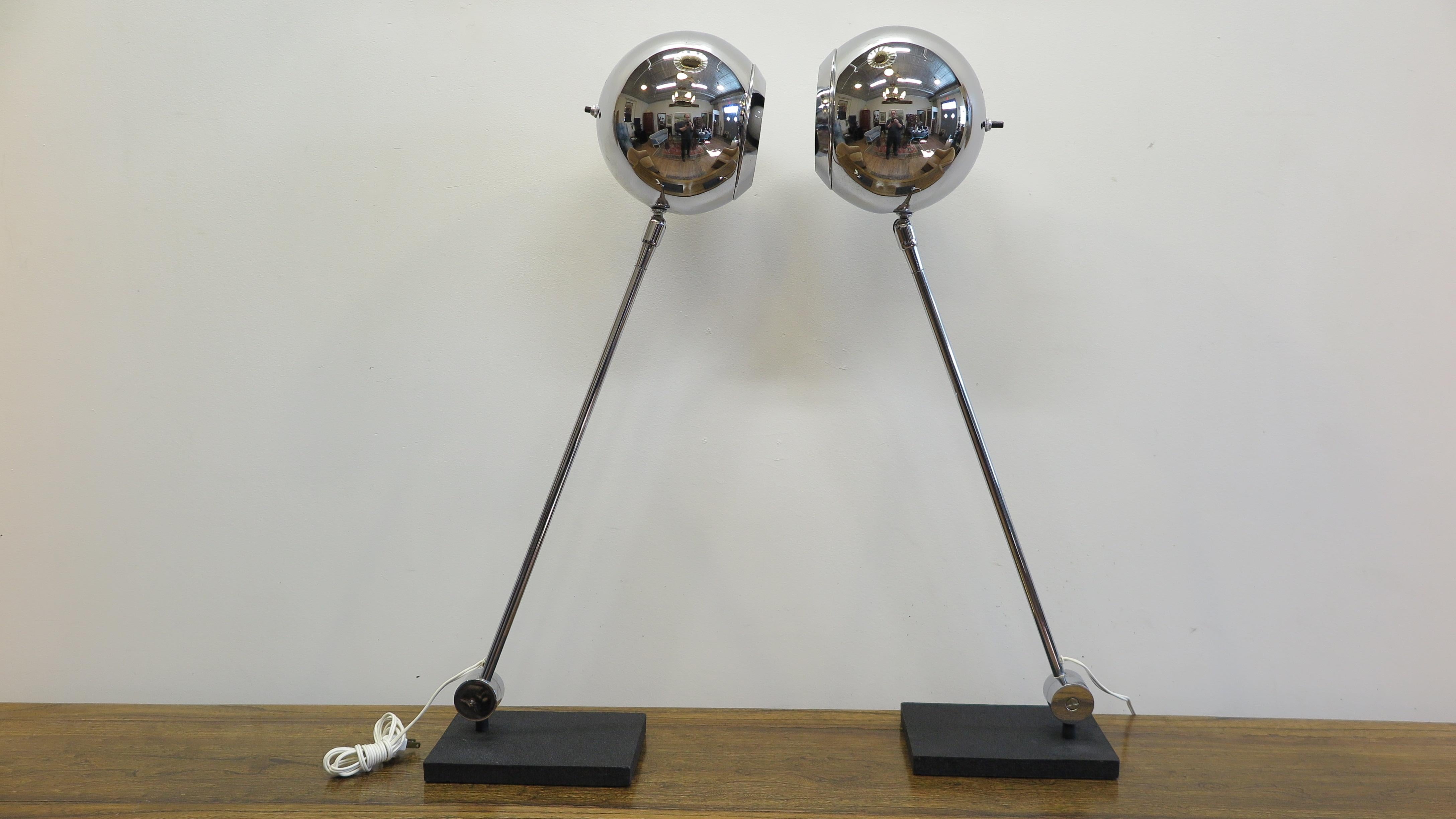 A pair of Robert Sonneman articulating table lamps. Robert Sonneman's iconic eyeball lamps mounted to Steel bases having articulating movement to both the Eyeball shade diffusers and arms. Shade diffusers have the Eyeball detail which is the boarder