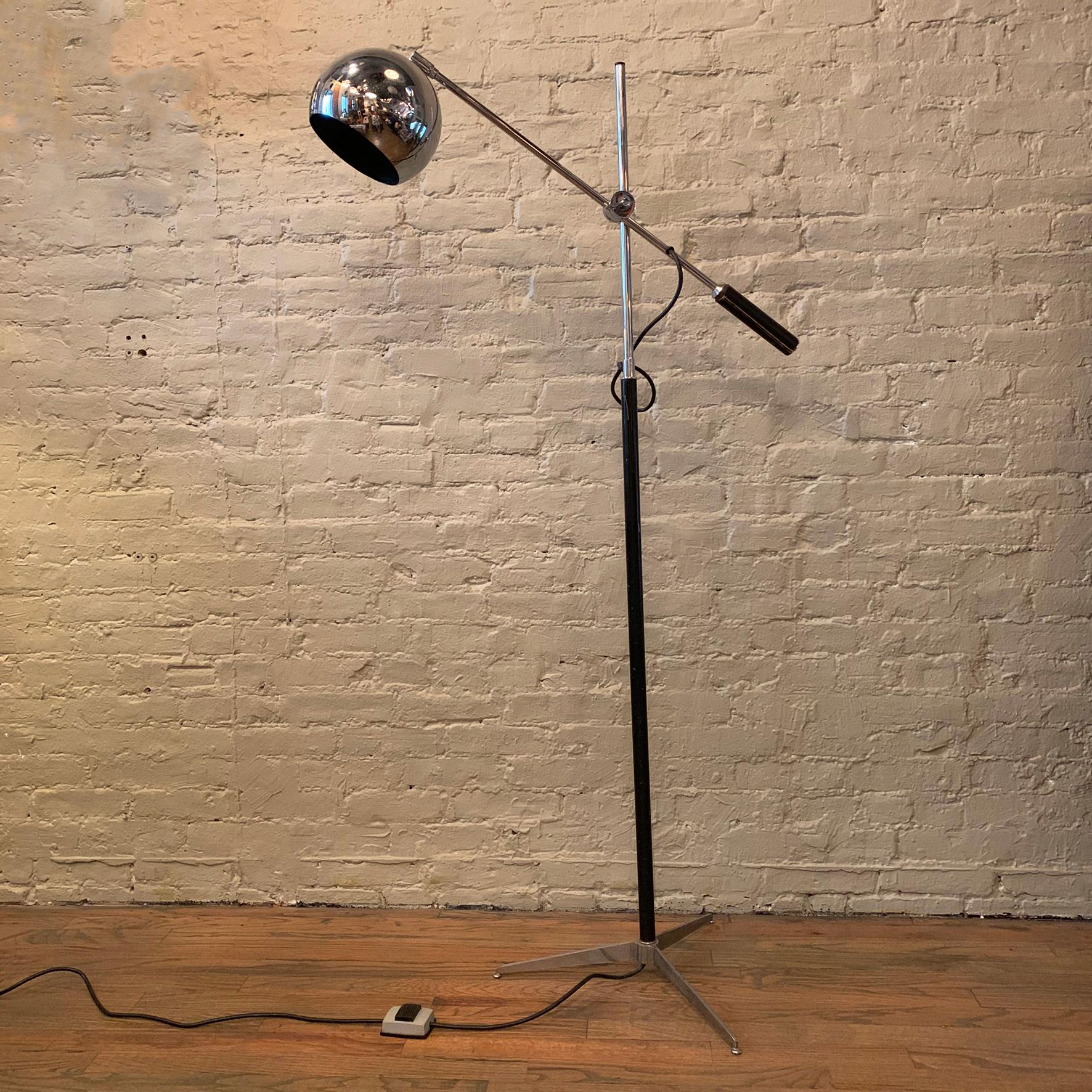 Mid-Century Modern, floor lamp by Robert Sonneman features a chrome and painted stem with tripod base and height adjustable extension arm with leather handle and eyeball shade. The stem height is 58 inches and the foot print is 20 inches. The arm