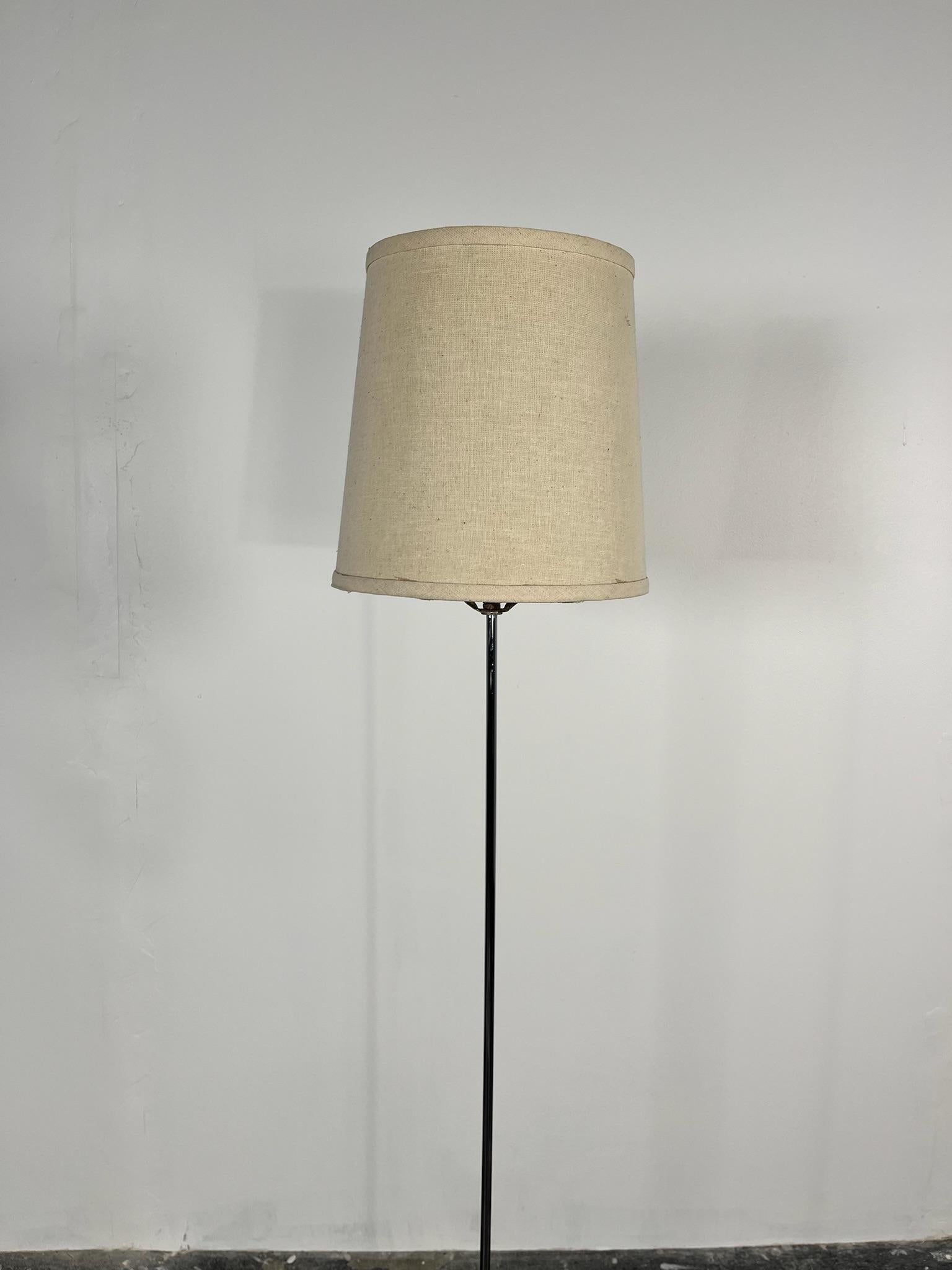 This is a petit and charming floor lamp designed by Robert Sonneman in chrome with its original shade. This Mid Century Modern light is in vintage condition with small dent in the bottom. (pictured)   This lamp presents beautifully. It gives a