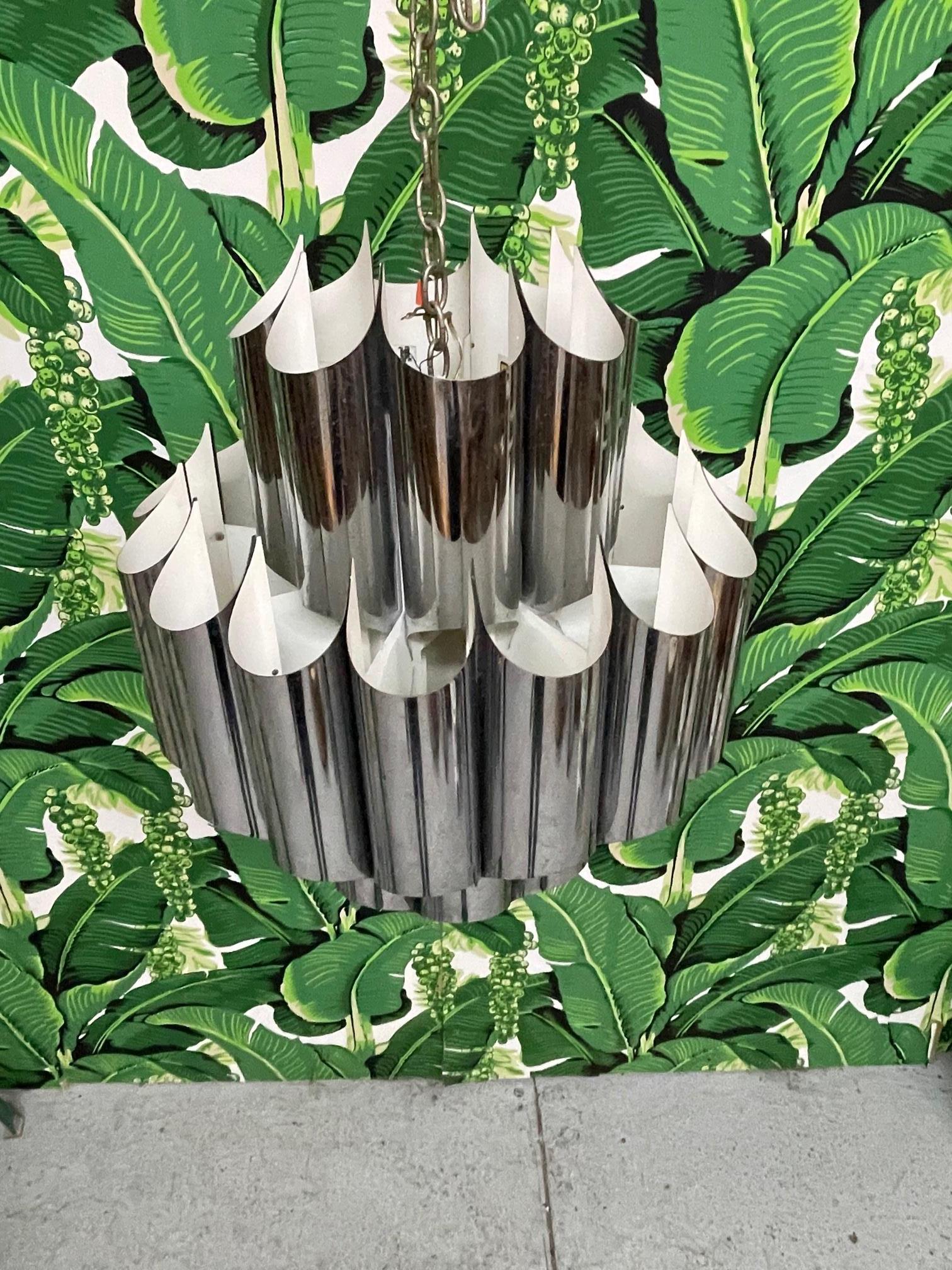 Iconic tubular chandelier features folded chrome tubes and bold Mid-Century Modern style. Four sockets. Good vintage condition with minor imperfections consistent with age.