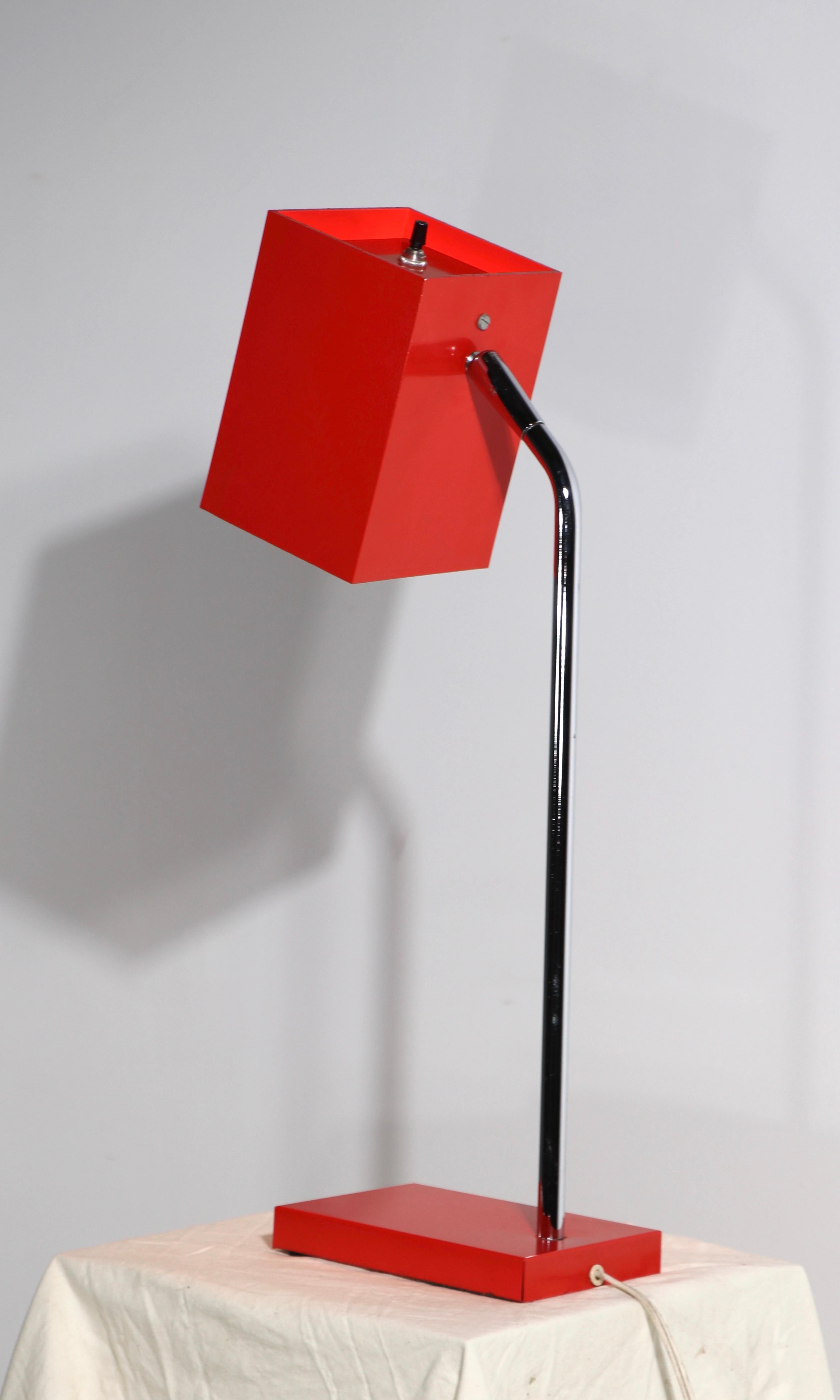 Bright red postmodern desk lamp designed by Robert Sonneman for George Kovacs. The lamp features the signature box form shade , which pivots and tilts to position the light, it is in very good, original, clean and working condition. 
 Shade 6 H x 4