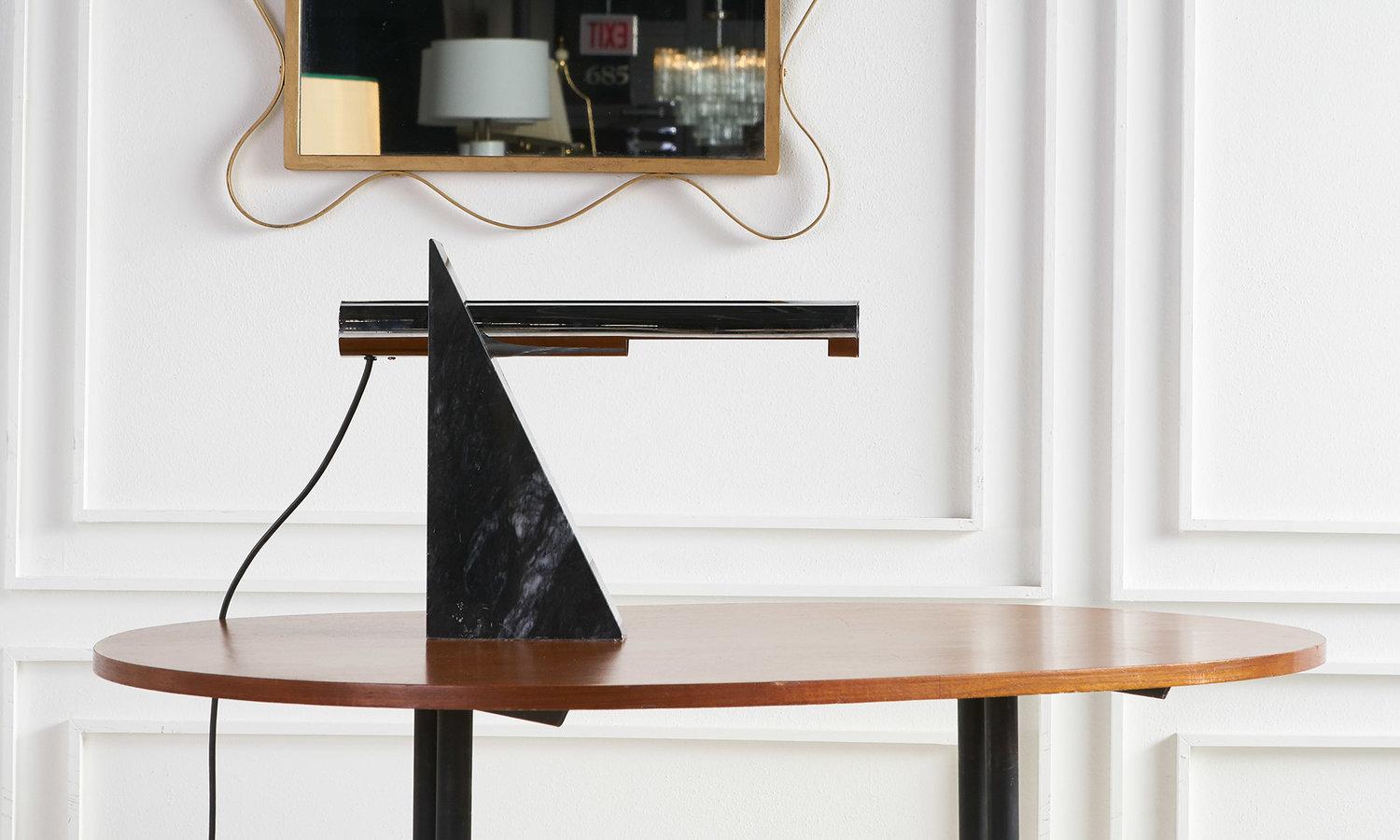 A sculptural table lamp by Robert Sonneman for George Kovacs featuring a nero marquina triangular base. 
 