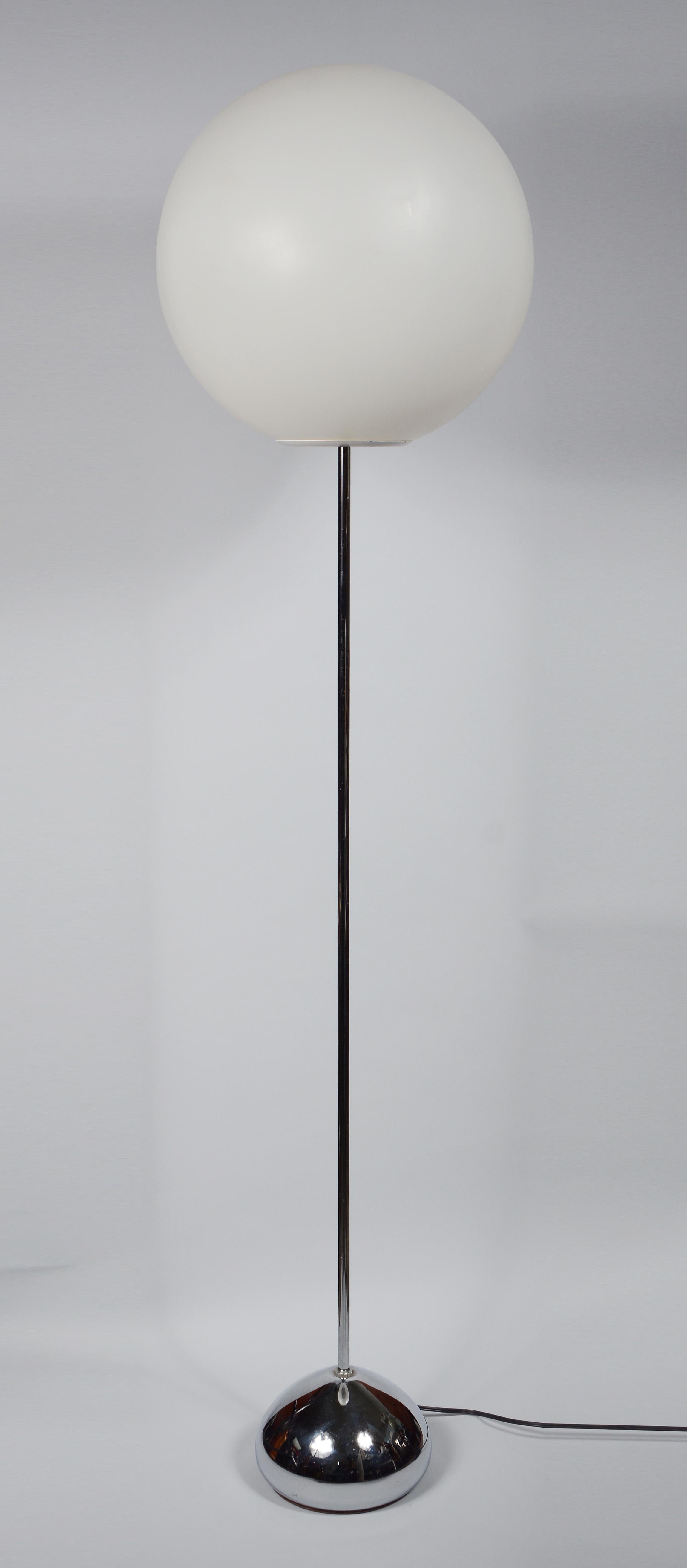 Chrome modernist floor lamp by Robert Sonneman. This has a teardrop shaped chrome base with a large plastic globe shade.