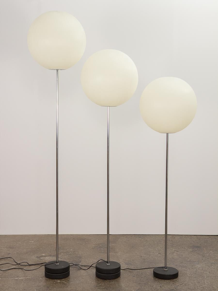 Set of three chrome globe floor lamps, designed by Robert Sonneman for George Kovacs. In graduated heights, the minimal yet sculptural form has a strong presence when grouped together or used individually. Spherical acrylic shades have a soft,