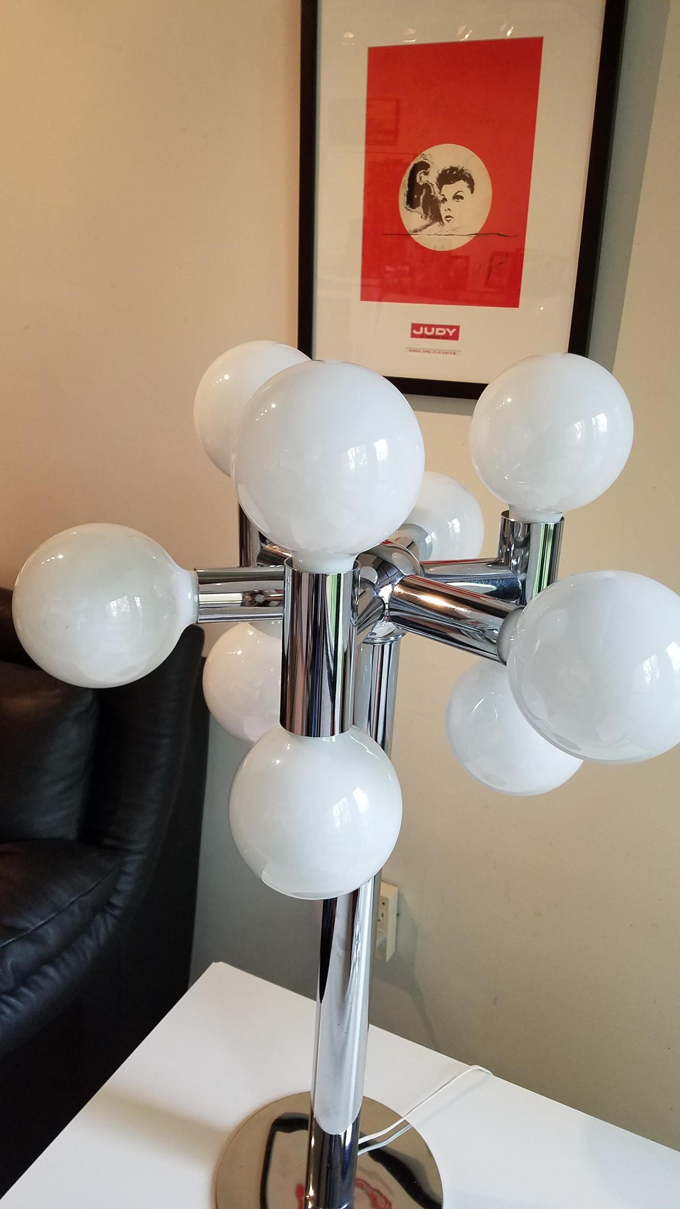 A wonderful tall atomic chrome lamp with nine large white globe 25 watt light bulbs as part of the design Very good condition. One very tiny dent on the chrome base please refer to pictures, does not detract. Otherwise chrome is excellent. 34.5