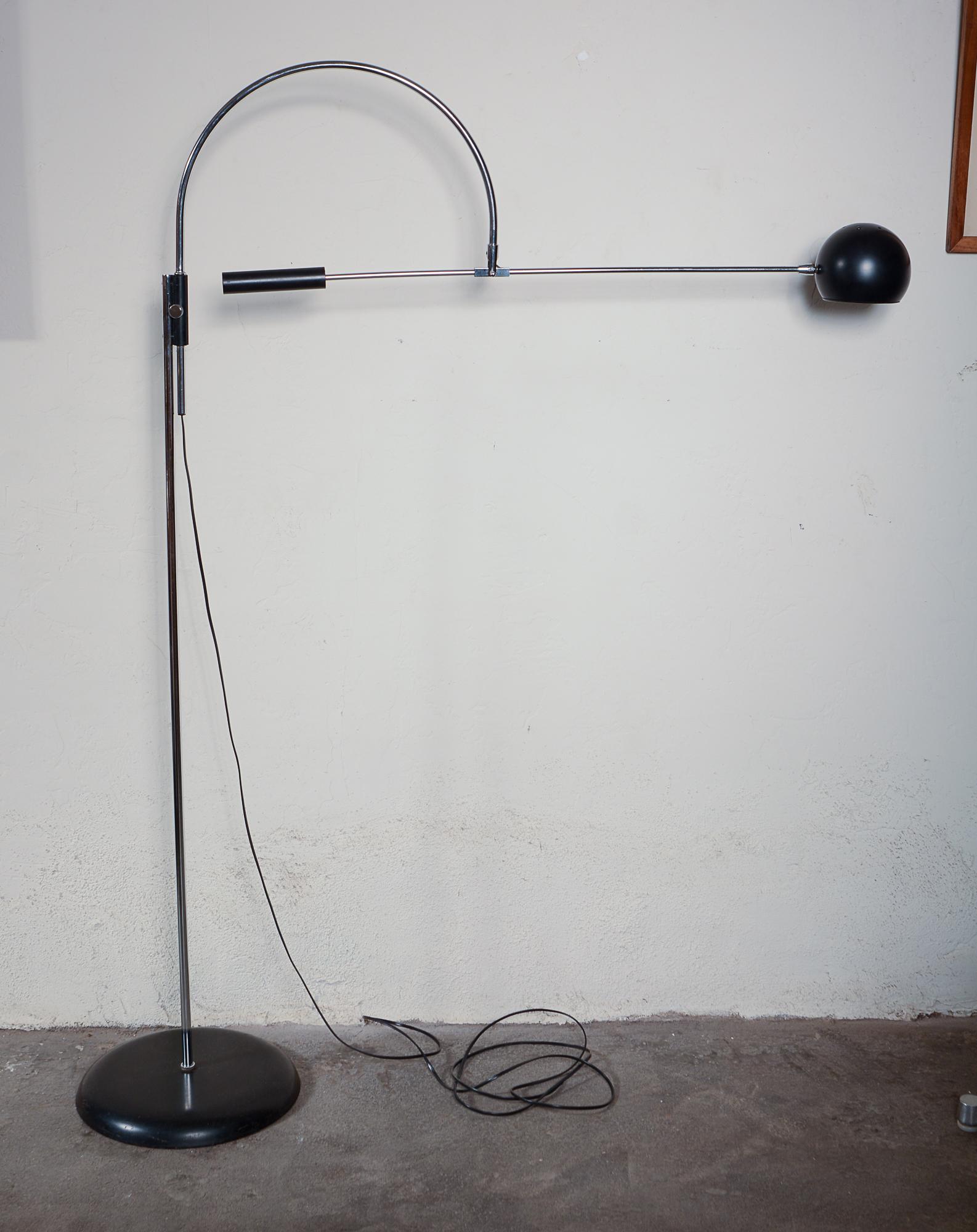 Adjustable floor lamp designed by Robert Sonneman. The arc portion rotates 360 degrees. The straight arm adjusts the shade up and down as well as side to side. This makes an excellent reading lamp or can be used to spot light a portion of a room or