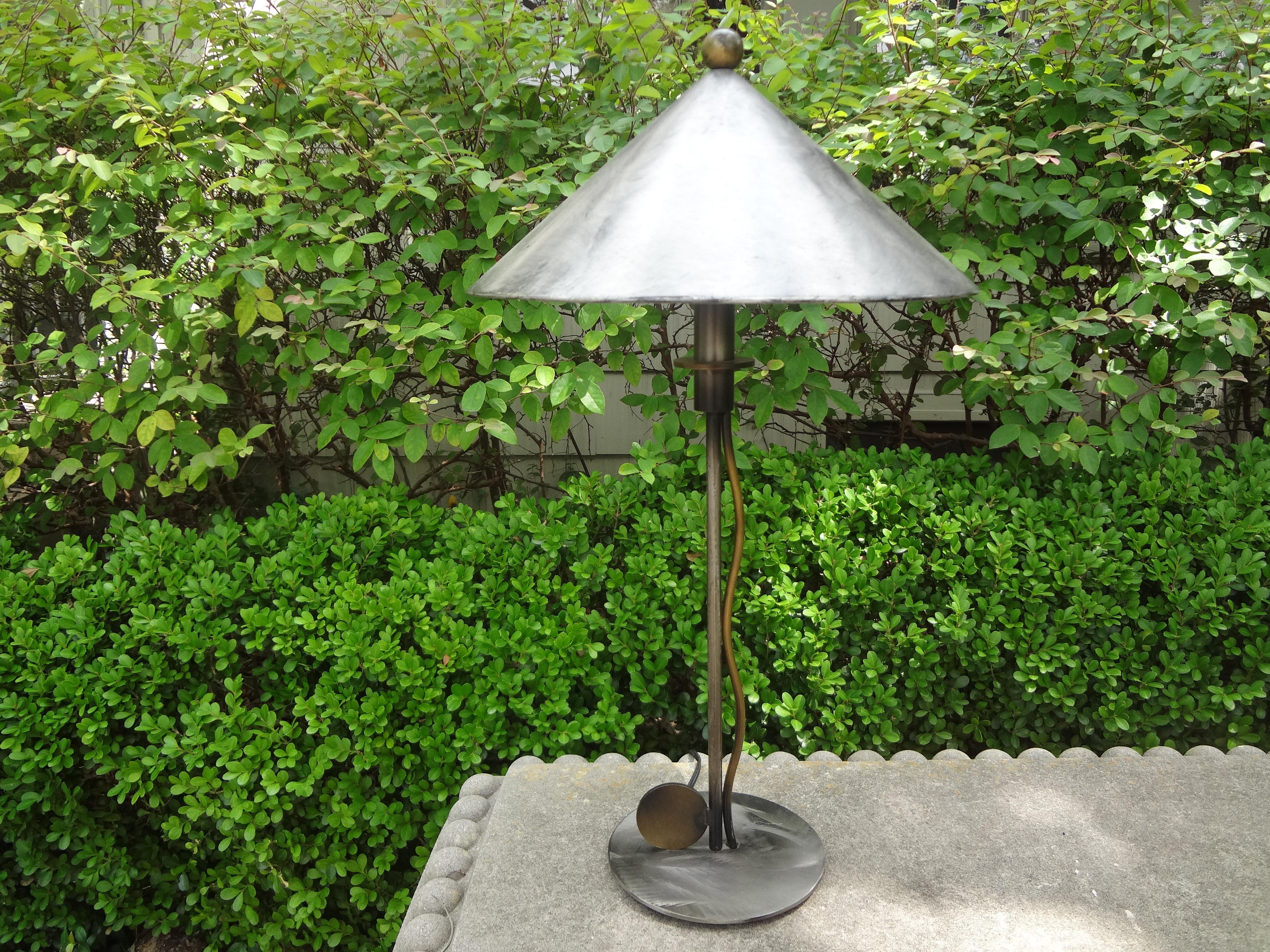 Robert Sonneman steel and brass lamp.
Handsome late 20th century steel and brass table lamp or desk lamp by Robert Sonneman. This unusual lamp is geometric in design with a cone shaped shade and a glass light diffuser.