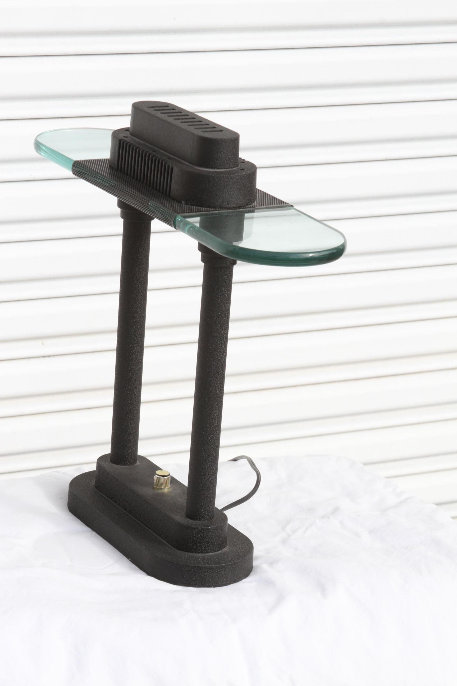 This is a Robert Sonneman Style lamp. It's a banker's desk lamp thats black with a glass top for a shade. This allows the lamp to be able to put out a strong light source without the constraints of a shade.