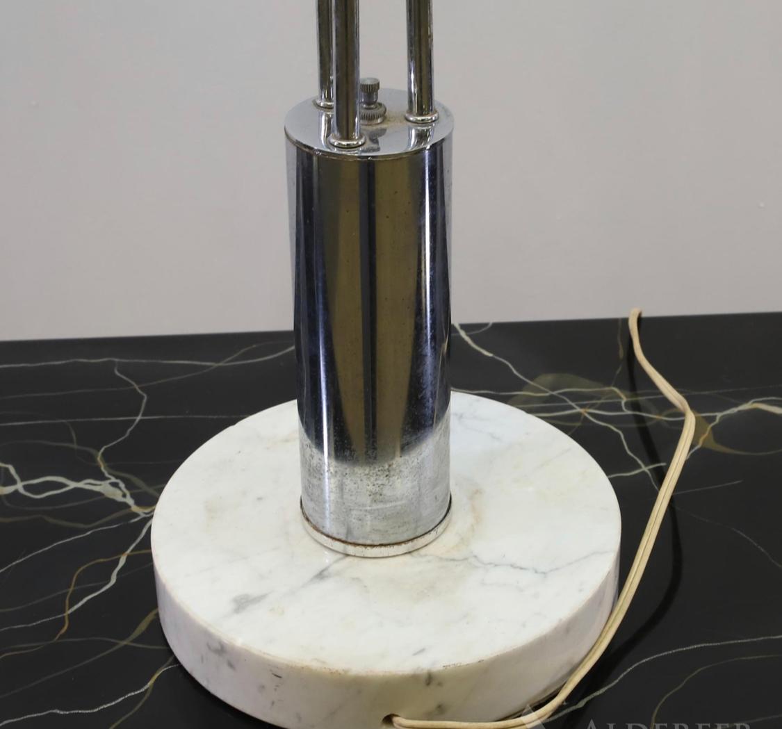 Absolutely stunning table lamp in the style of Robert Sonneman. 3 chrome shades an adjustable arms pivot atop marble base.