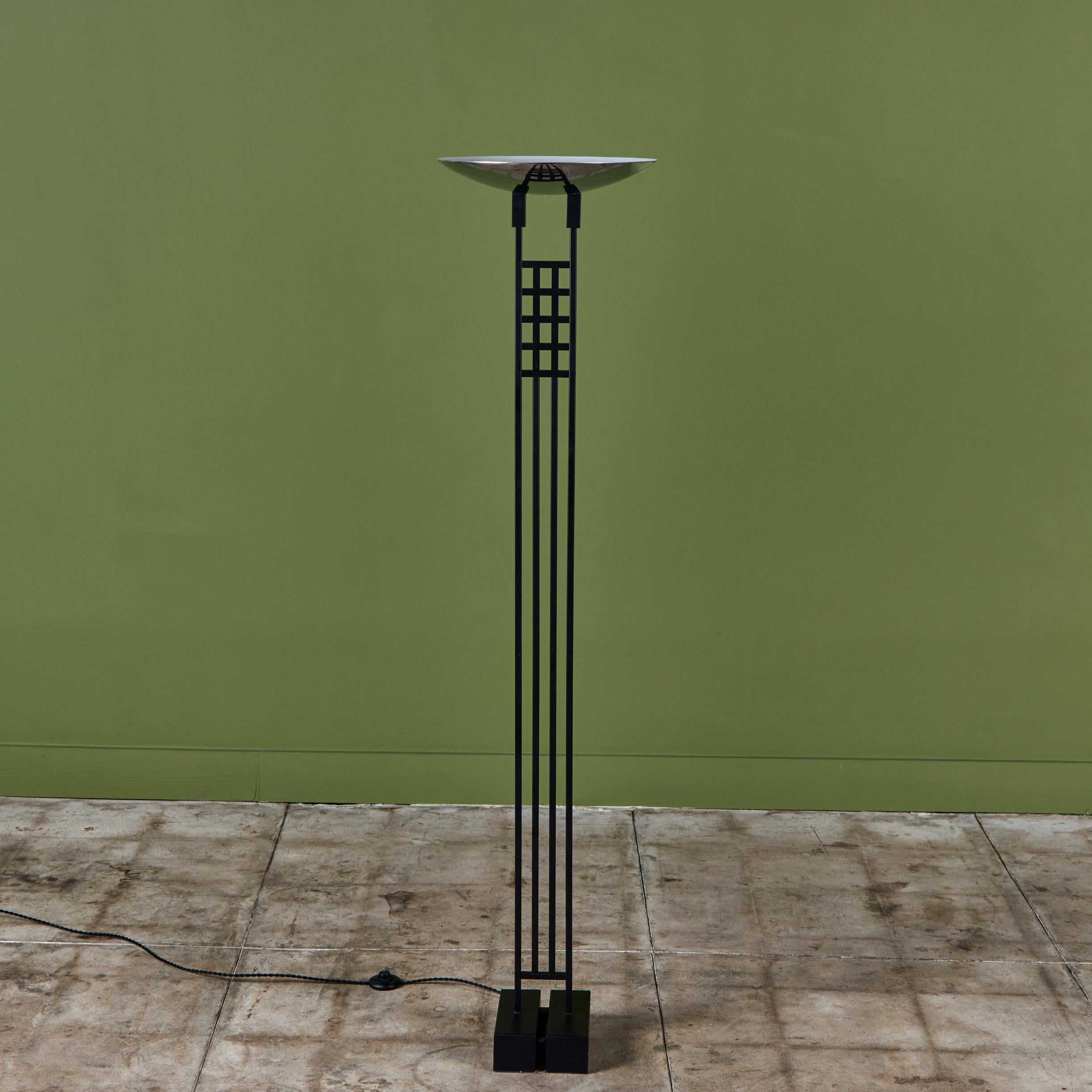 Postmodern torchiere floor lamp by Robert Sonneman for George Kovacs, c.1980s, USA. The lamp features a slim profile geometric grid stem and chrome dish. The dish offers an uplight. The lamp rests on a heavy rectangular base. Newly rewired with toe