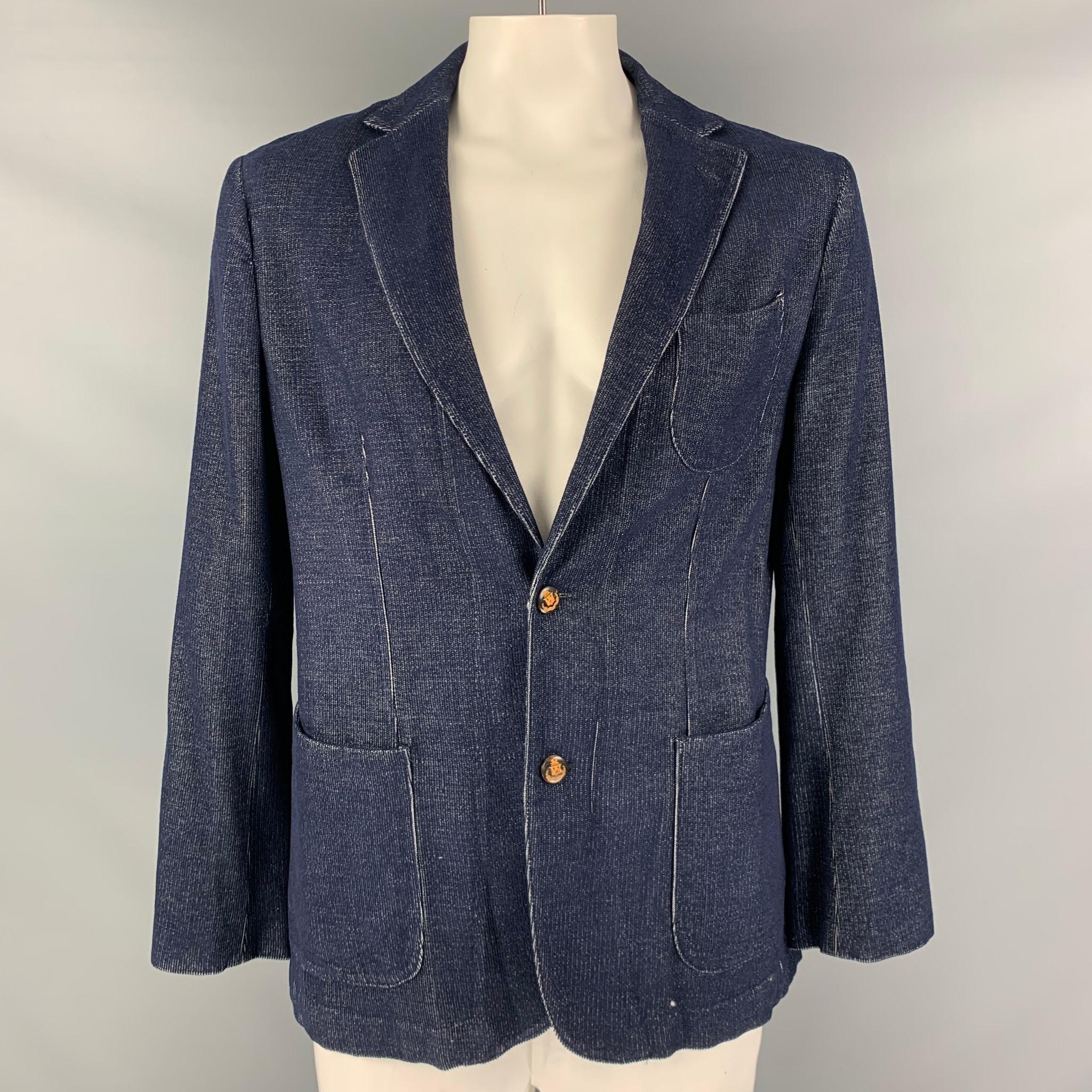 ROBERT TALBOTT jacket comes in a navy and white cashmere corduroy with a single breasted, unlined, and two button sport coat with a notch lapel.

Excellent Pre-Owned Condition.
Marked: L

Measurements:

Shoulder: 18 in.
Chest: 48 in.
Sleeve: 25.5