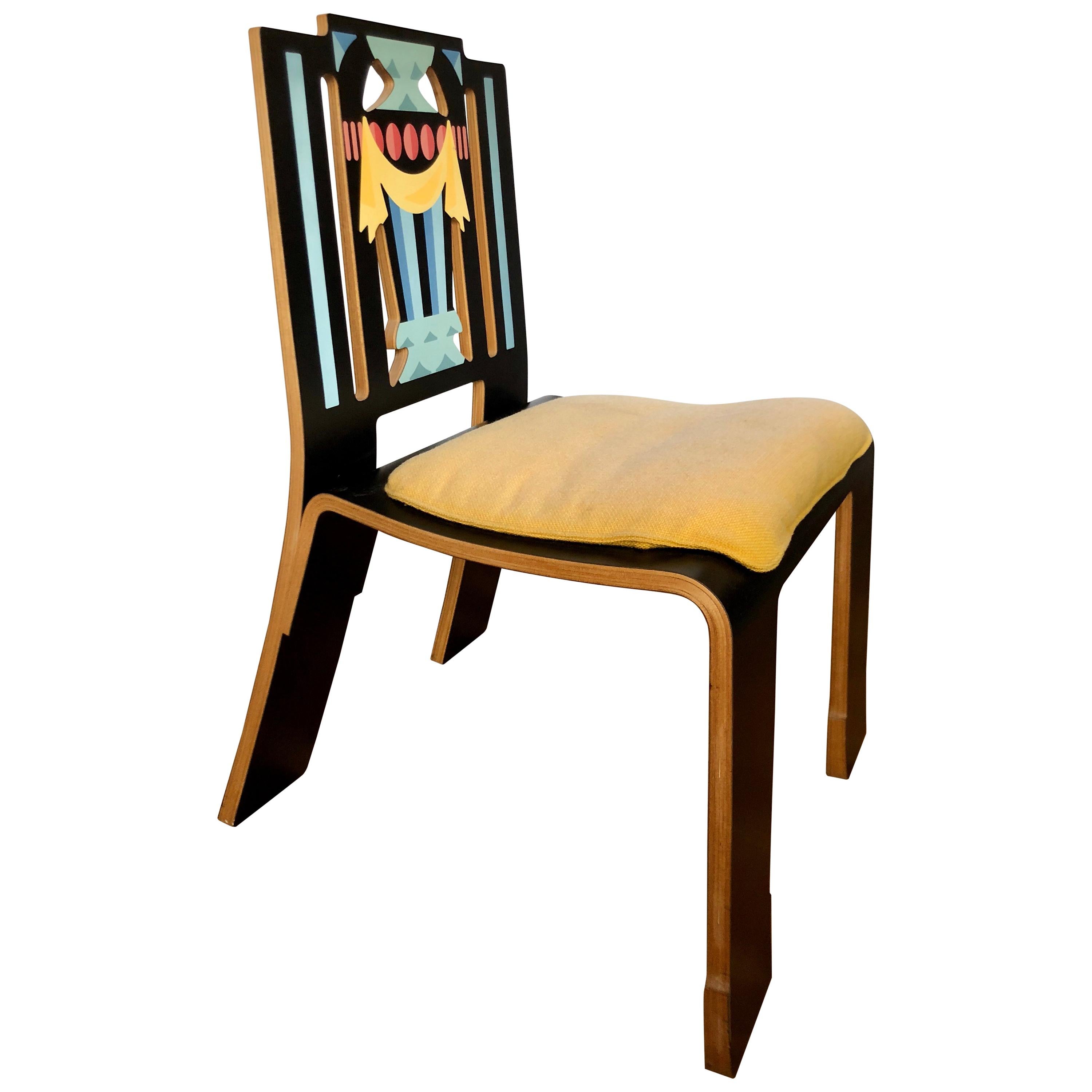 American, black laminate on wood substrate with decal decoration and yellow wool seat cushion, for Knoll Furniture, circa 1984. This witty play on classical form is one of the icons of Postmodernist furniture design.