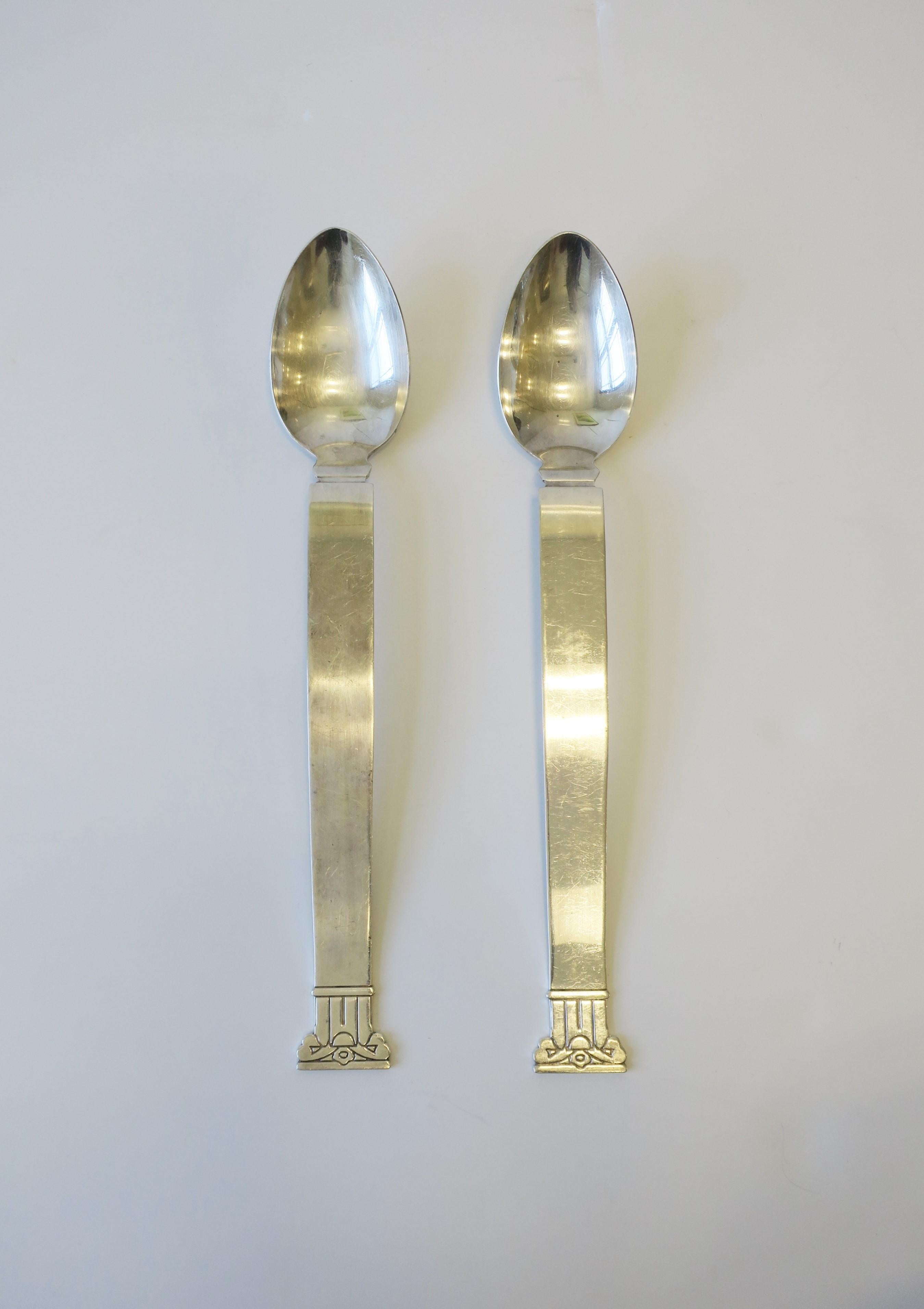 A beautiful, chic and substantial set of designer Postmodern sterling silver-plate serving, salad or platter spoons with a Neoclassical pillar column handle design, designed by Robert Venturi for Swid Powell, circa 1990s. Each measure: 14.25