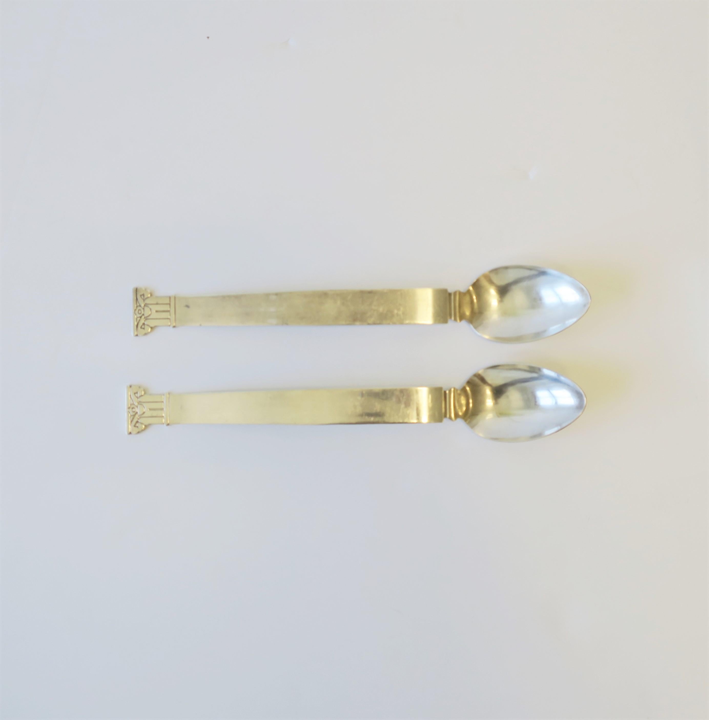 A beautiful, chic, substantial, and iconic set of designer Postmodern sterling silver-plate serving, salad or platter spoons with Neoclassical pillar column handle design, designed by architect Robert Venturi for Swid Powell, circa 1990s. Each