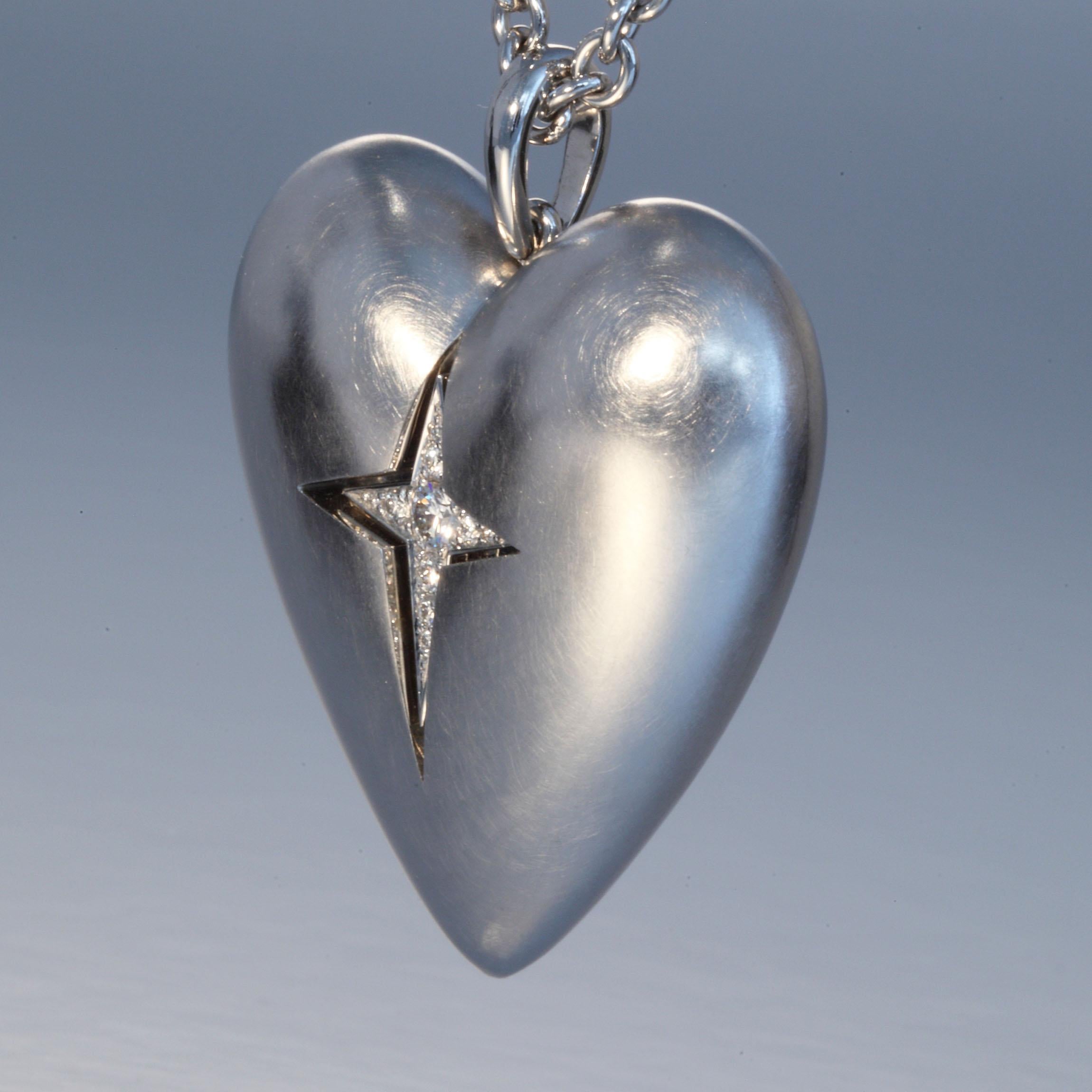 This 950 platinum heart is set with 0.16 carats Diamonds F,G vvs on a hand made 950 platinum chain. It is designed and hand made in Zurich, Switzerland by Robert Vogelsang and is a one of a kind piece signed RV.
The heart and chain is in 950