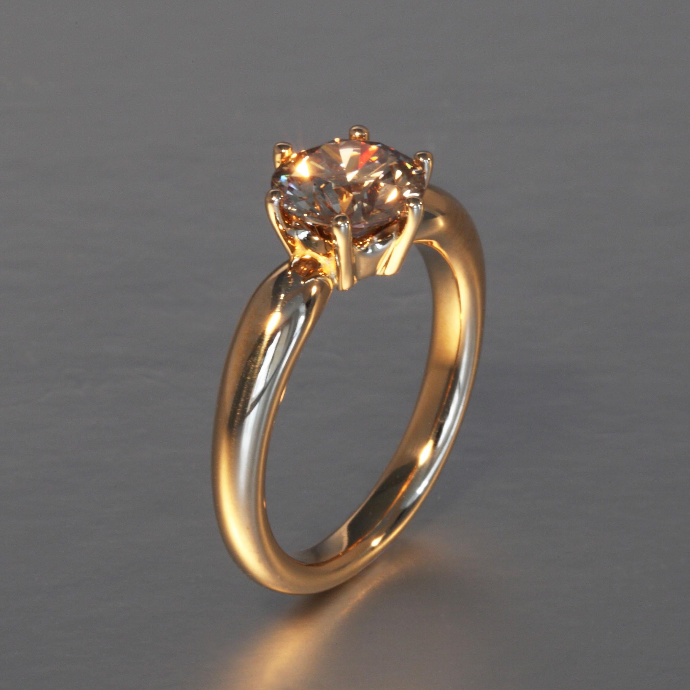 This 1.43 carat natural brown diamond is mounted in a solitaire rose gold ring. This one of a kind piece is designed and hand made, no casting, in Zurich, Switzerland by Robert Vogelsang and signed RV.

It is set in 18 Karat rose gold and weighs 5.2