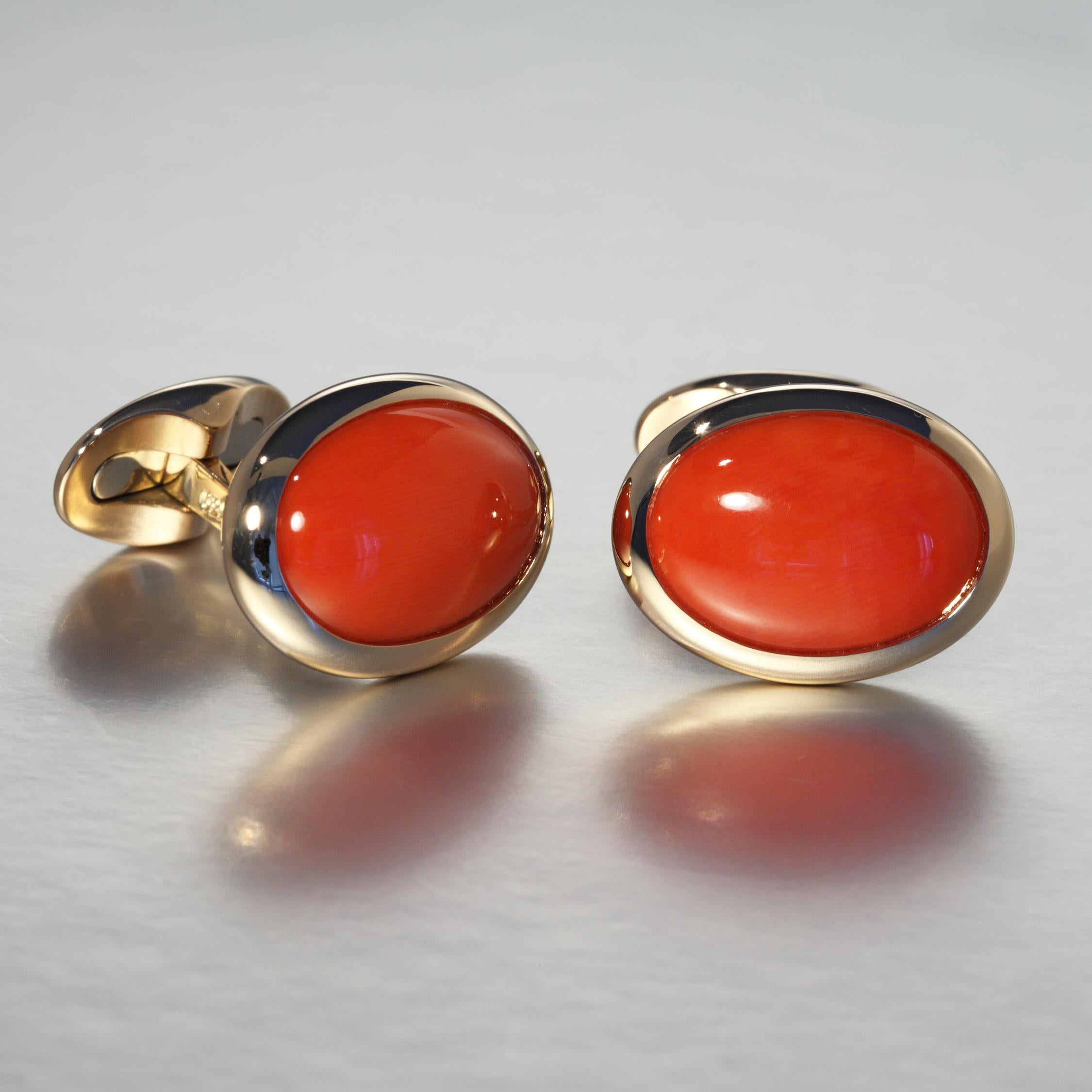 This pair of cufflinks is set with two oval red coral cabochon 18.81 carat in 18 Karat rose gold. The cufflinks are hand made in Zurich, Switzerland by Robert Vogelsang and are one of a kind piece signed RV.

The cufflinks are set in 18 Karat rose