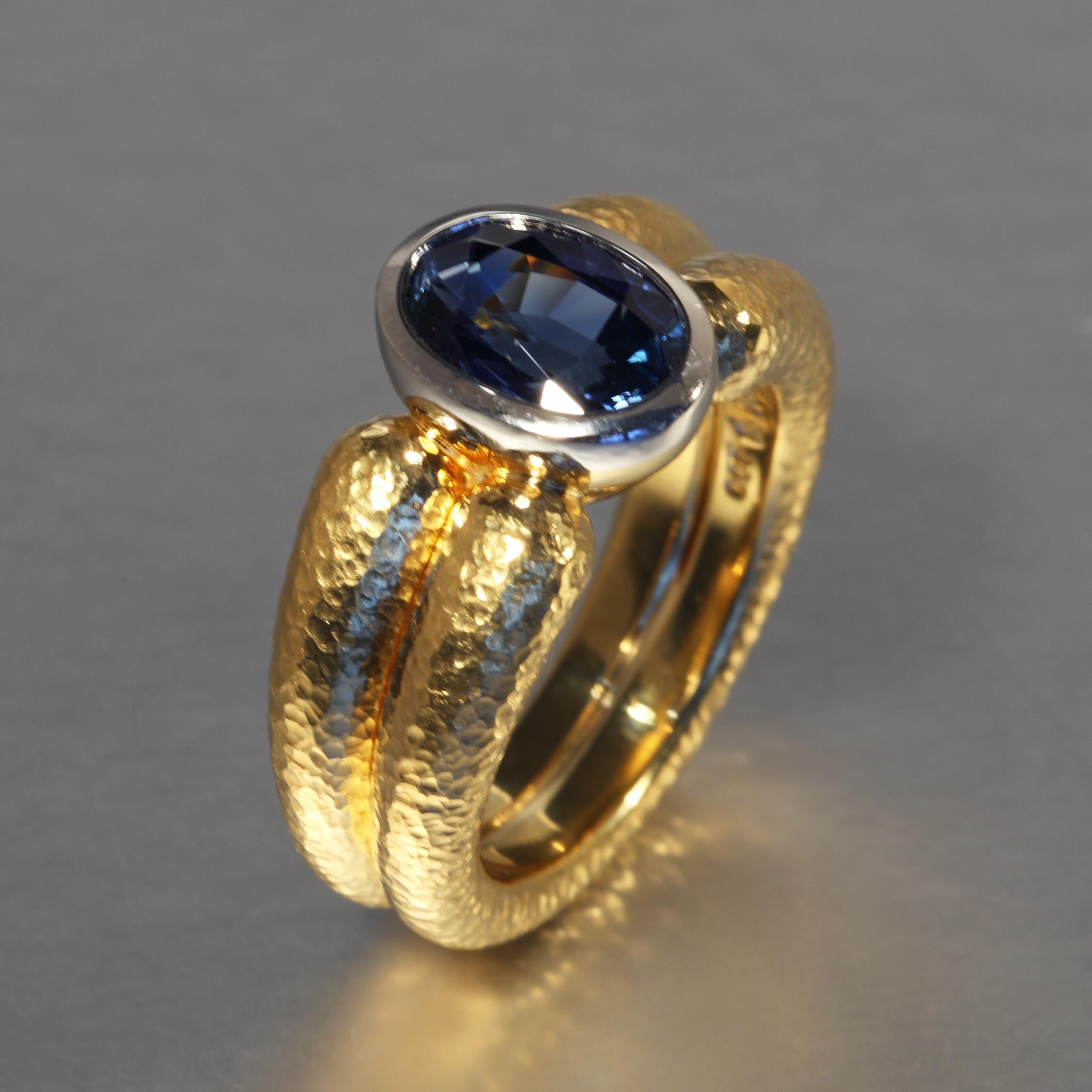 This natural 3.07 carat oval blue Sri Lanka sapphire is set in a gold ring with a platinum rim around the stone. The sapphire is accompanied by a GRS Report stating no indication of thermal treatment. It is designed and hand made (no casting) in