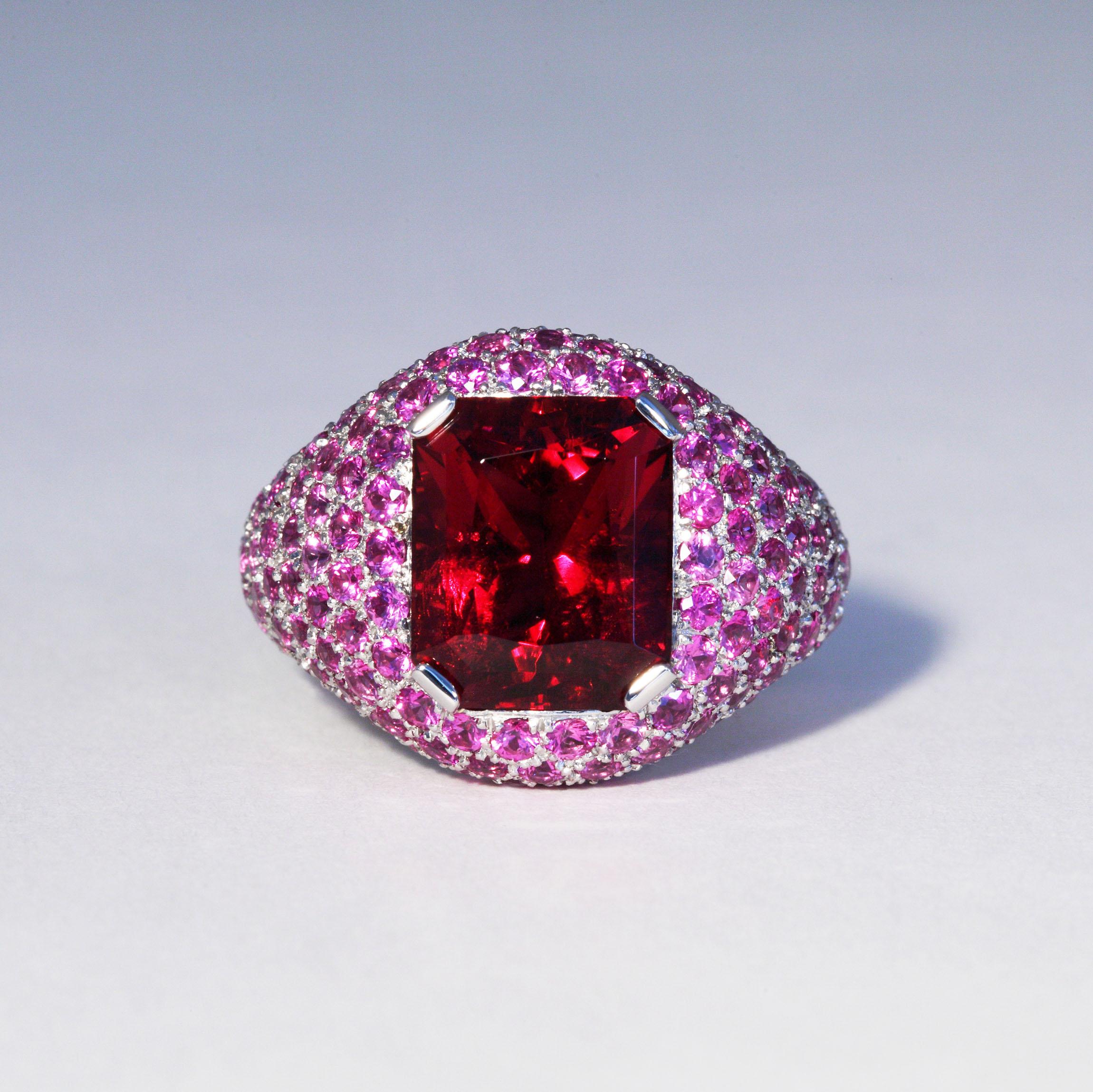 This fine octagonal Rubelite Tourmaline of 5.91 carats is set in a platinum ring with 4.14 carats pink Sapphires. An inner spring moves easily over the knuckle and holds the ring in place. It is designed and hand made in Zurich, Switzerland by