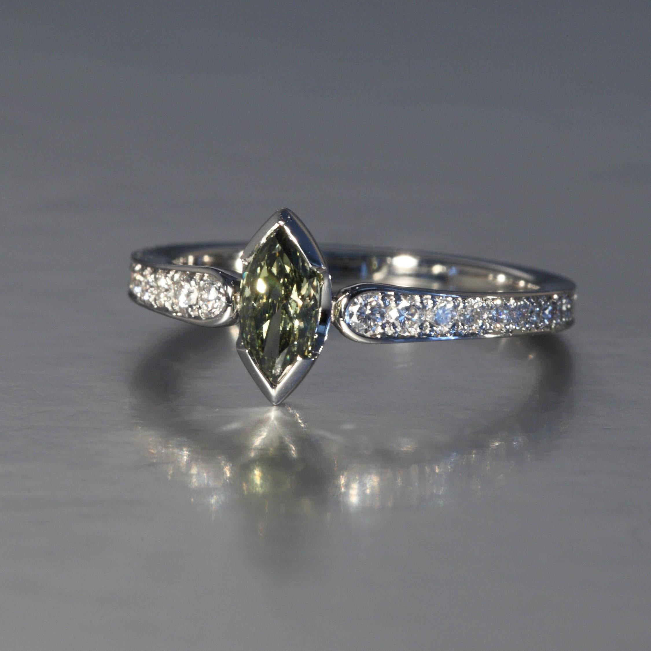 This 0.45 carat natural, fancy grayish yellowish green marquise cut diamond is accompanied by a GIA certificate. The ring is mounted in platinum with additional 0.20 carats brilliant cut diamonds F,G vvs. This one of a kind piece is designed and