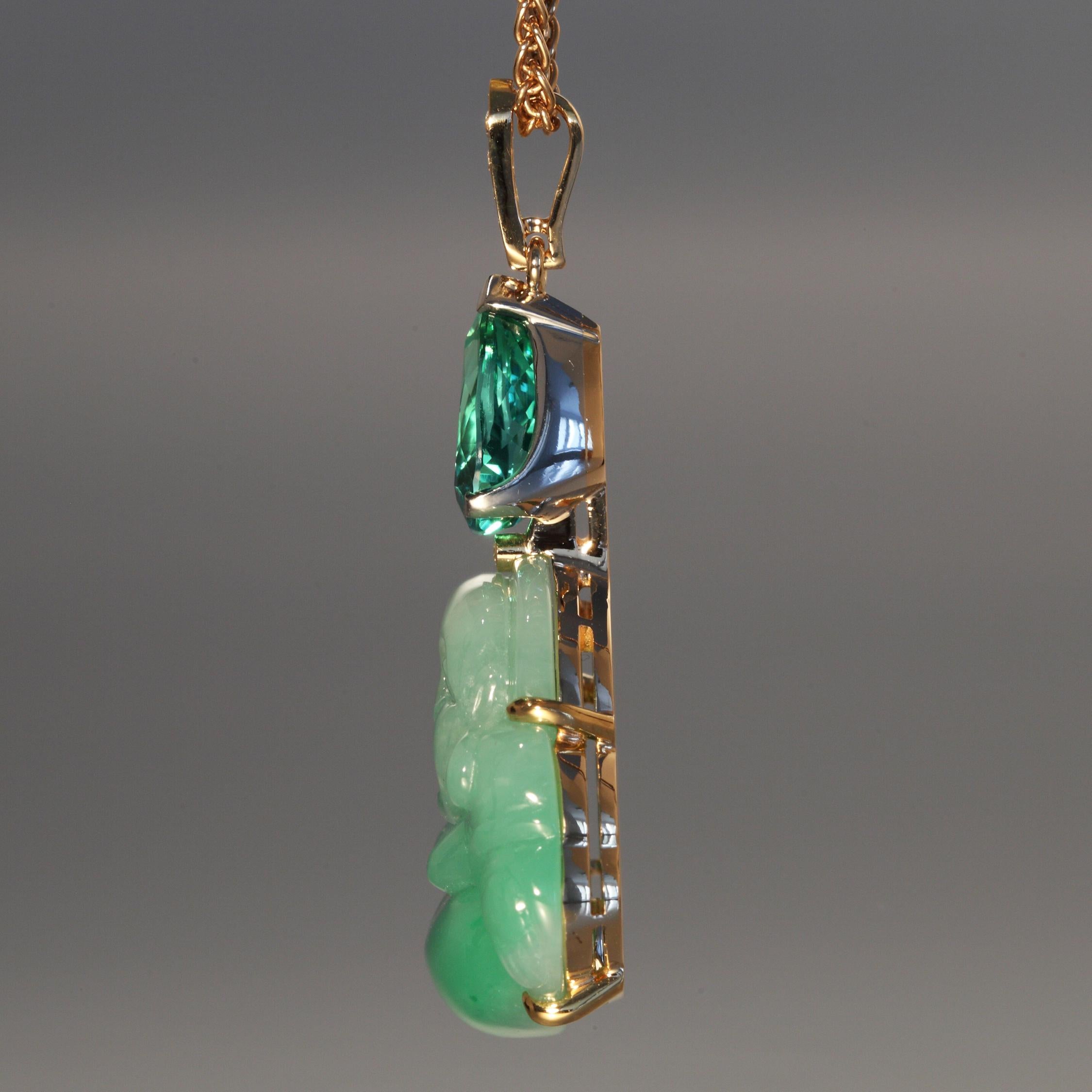 This 42.69 carat green Jade laughing Buddha carving is set with a 4.22 carat green tourmaline drop and 0.04 carats diamonds F,G vvs in rose gold and platinum pendant on a rose gold braid chain. The tourmaline is accompanied by a GRS Report. The