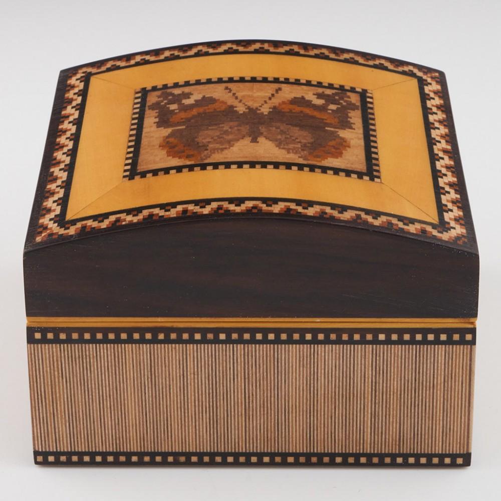 Heading : Robert Vorley Tunbridge ware jewellery box
Date : 2021
Period : Elizabeth II
Origin : Essex
Decoration : Domed cover with central Red Admiral butterfly within keylines and a geometric border. The side panels decorated with vertical striped