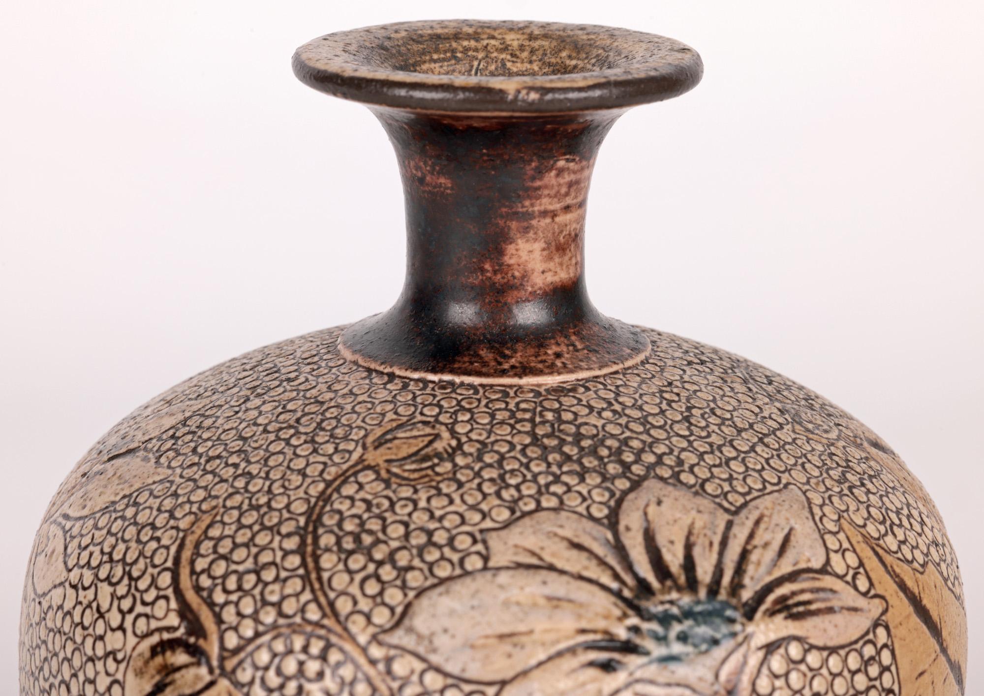 An exceptional early Martin Brothers floral decorated vase by Robert Wallace Martin dated 1881. This finely made stoneware vase is of rounded bulbous shape standing on a narrow round pedestal foot and with a narrow funnel neck top with a wide folded